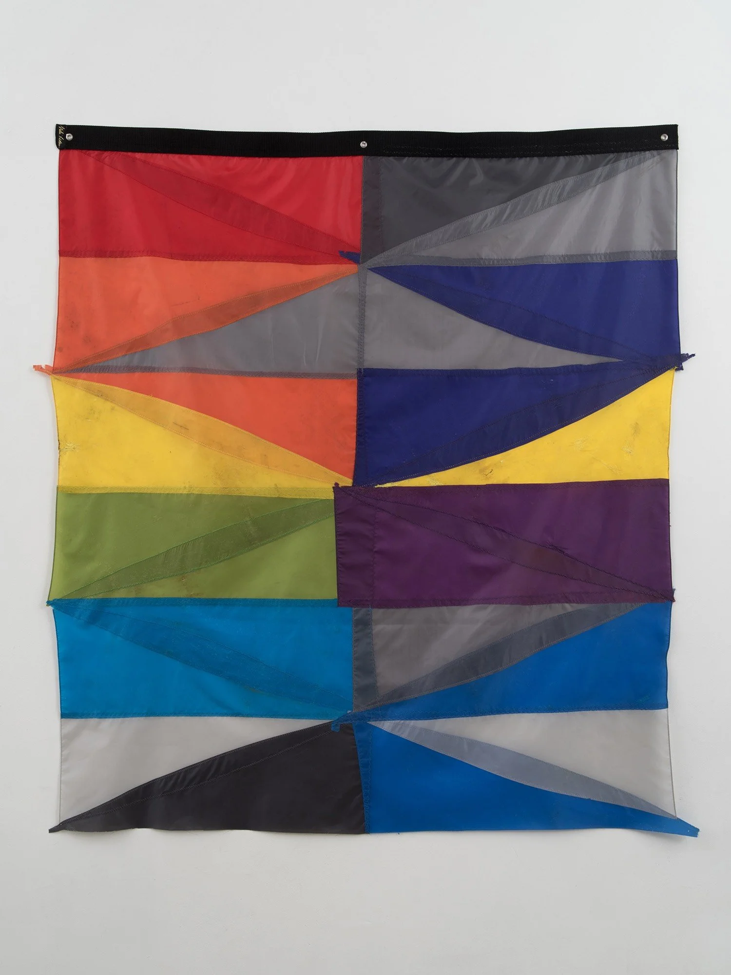 Multicolored hanging wall sculpture made with umbrella canopies, nylon thread, nylon webbing, grommets.