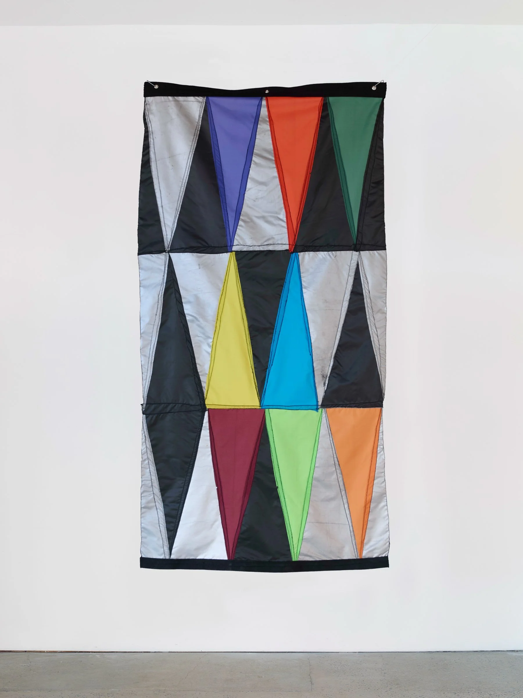 Double Digit Diptych Black, wall-mounted textile artwork with geometric triangular panels in black and multicolored fabric