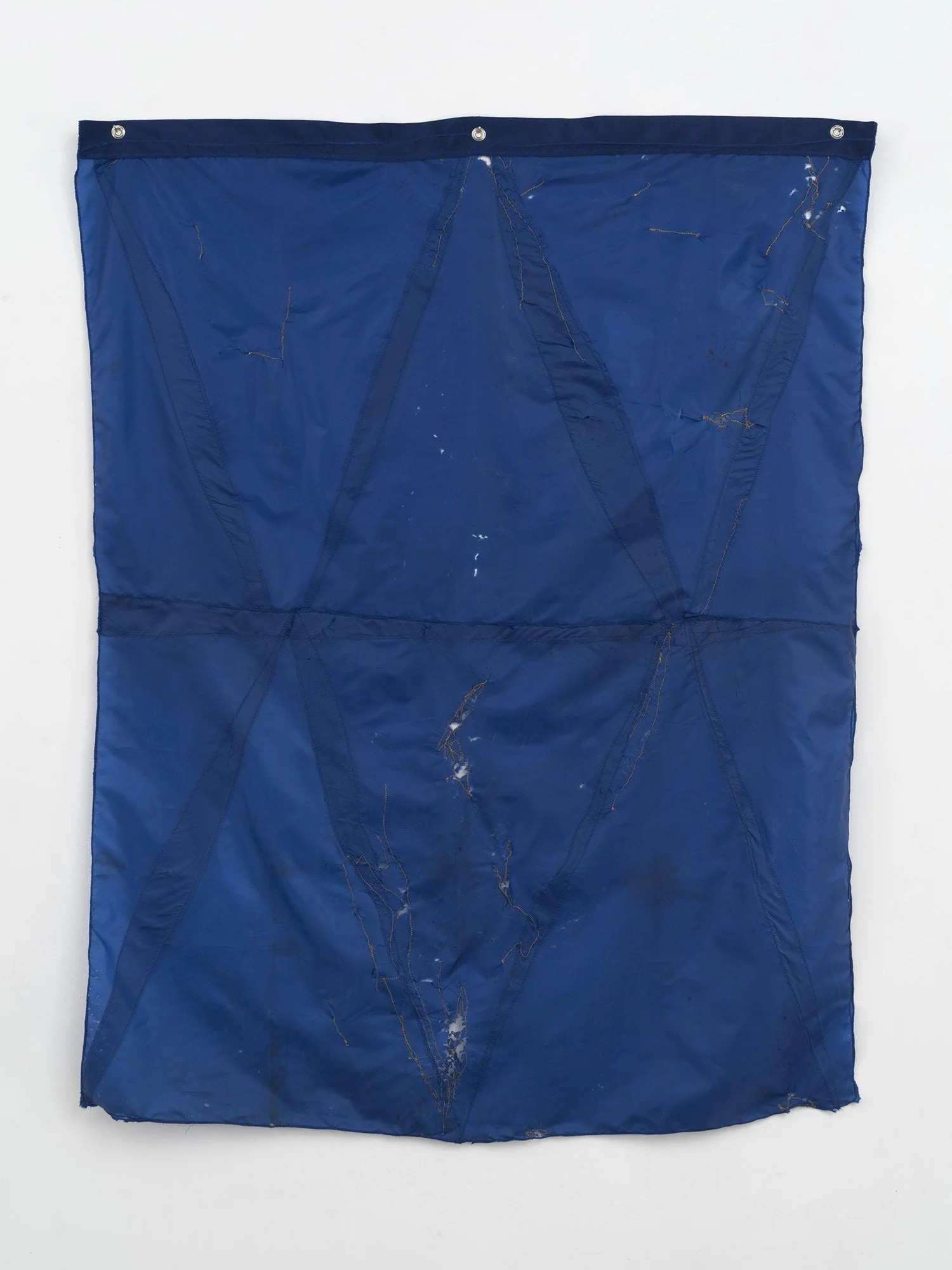 Hanging sculpture made of dark colored umbrella canopies, nylon thread, nylon webbing, grommets