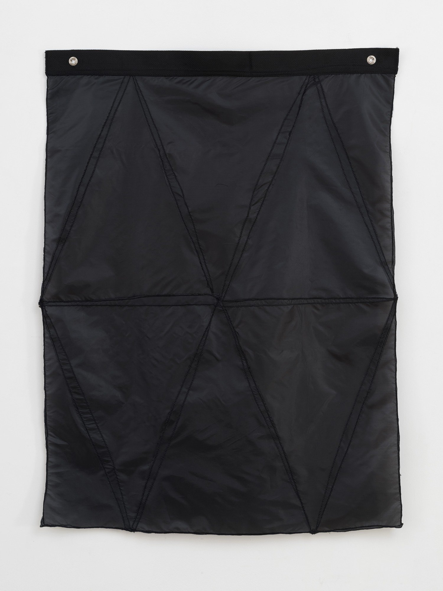 Hanging sculpture made of dark colored umbrella canopies, nylon thread, nylon webbing, grommets