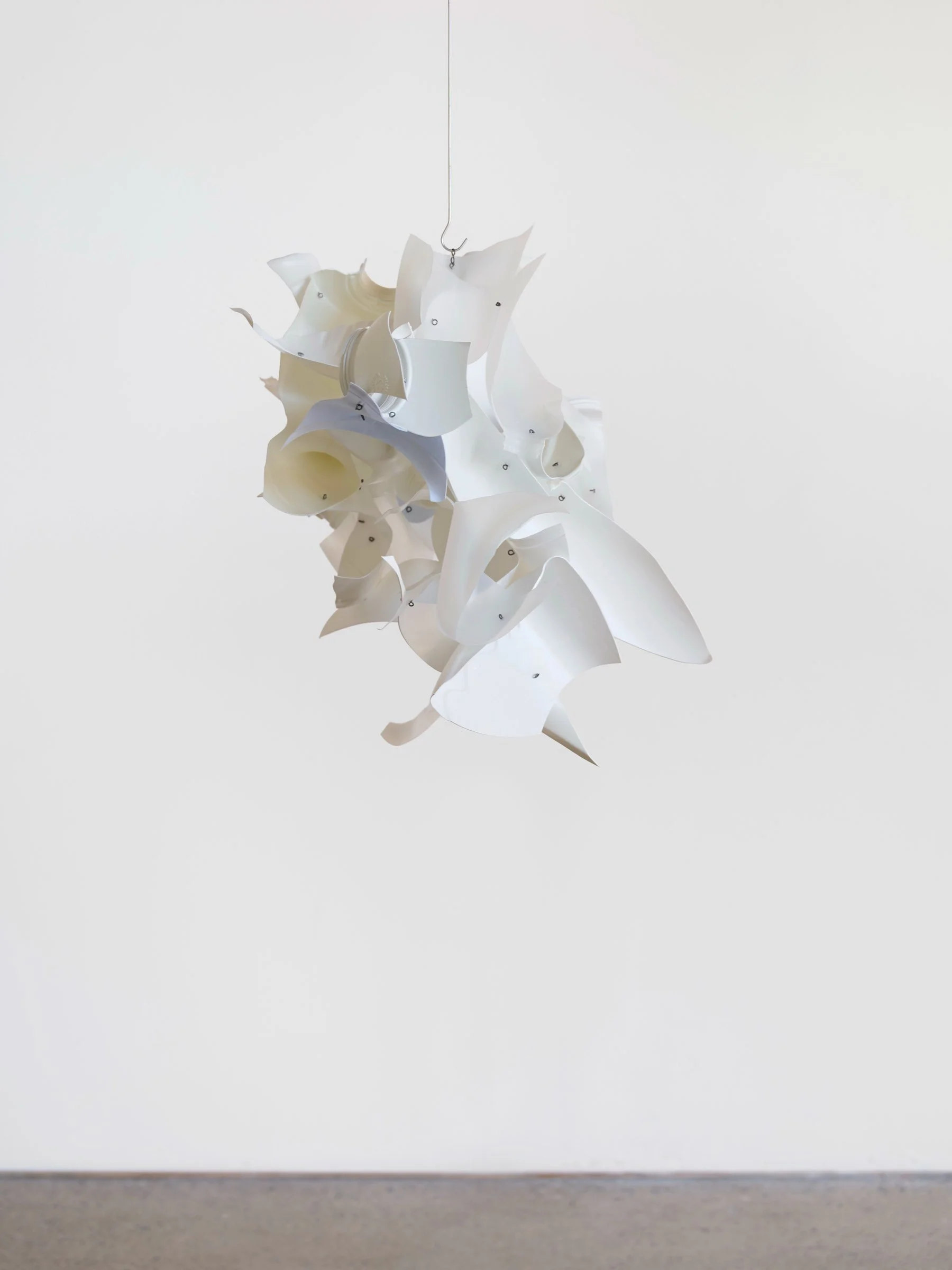 Cloud Car, suspended sculpture of layered white plastic pieces with curved edges arranged in a floating composition