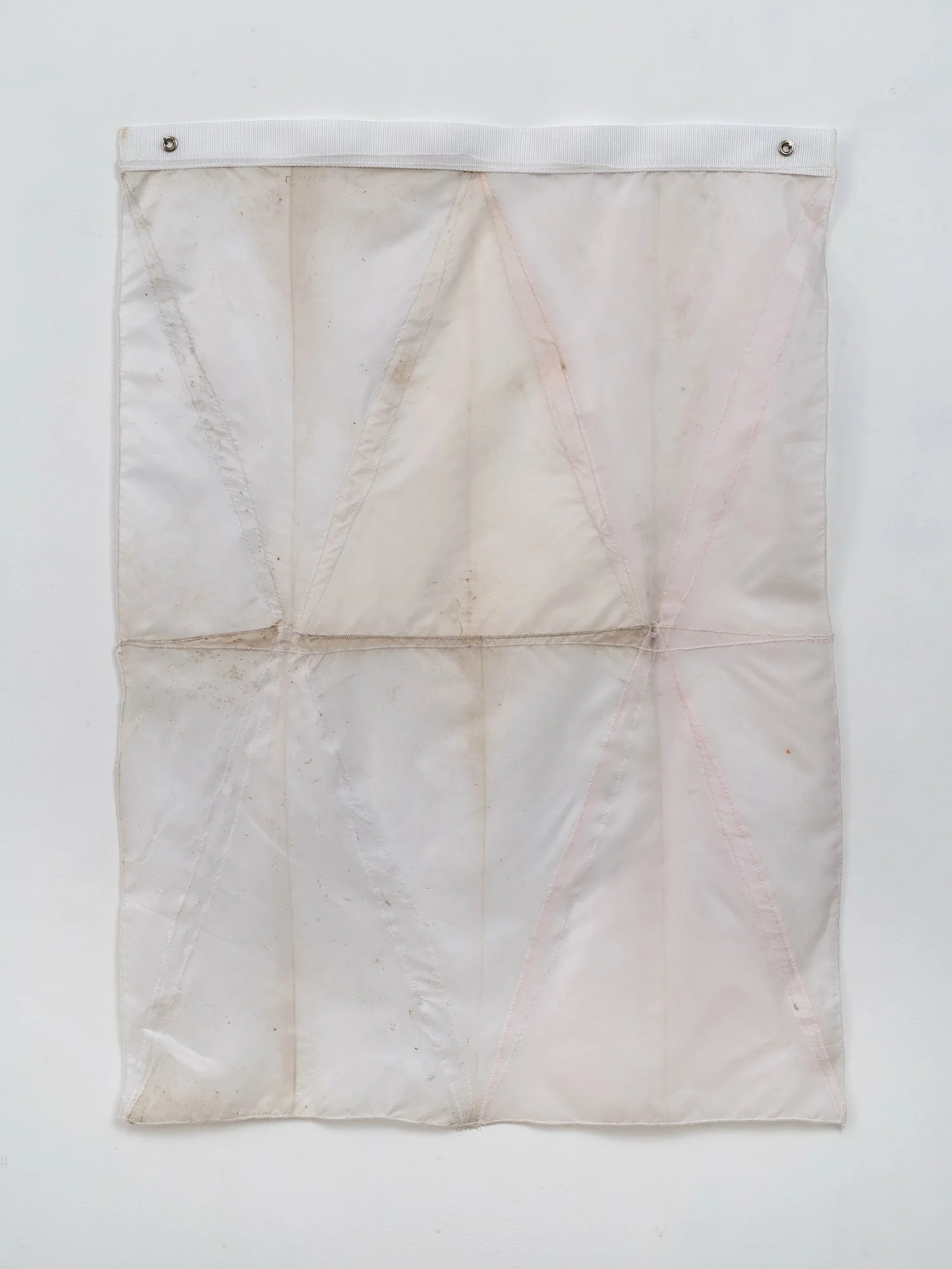 Hanging sculpture made of light colored umbrella canopies, nylon thread, nylon webbing, grommets