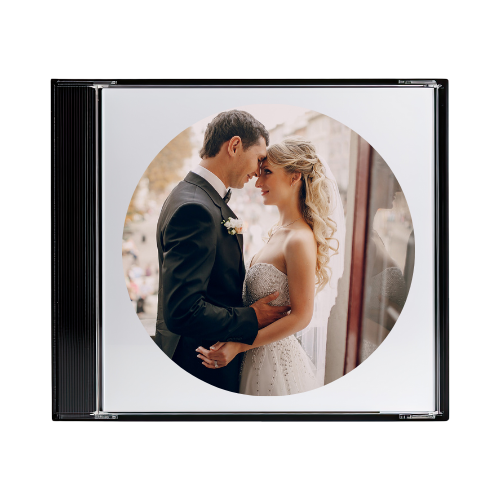 A framed photo of a bride and groom on their wedding day, standing close and looking at each other indoors with natural light.