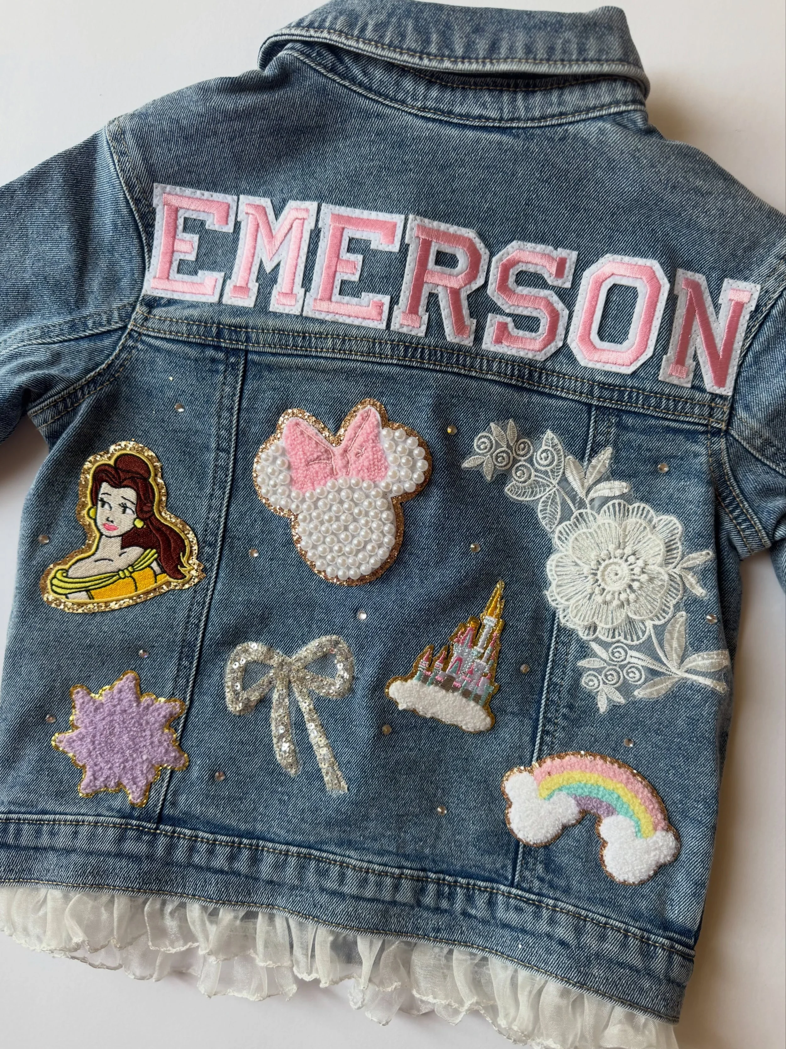 A little Disney magic mixed with dreamy LoveShackFancy vibes ✨🎀🏰 Featuring a sewn-in ruffle, sparkling rhinestones, and so many thoughtful details &mdash; this one-of-a-kind custom piece was truly made with so much love 💖