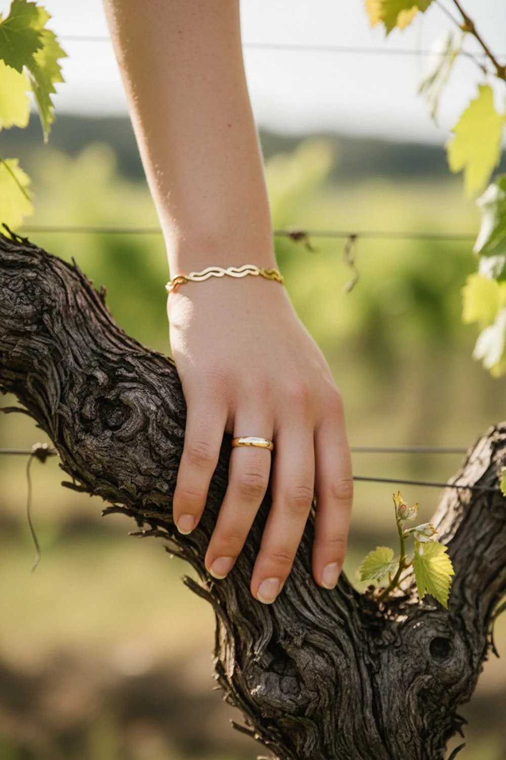 Minimalist gold wedding jewelry and accessories with a botanical vineyard theme.