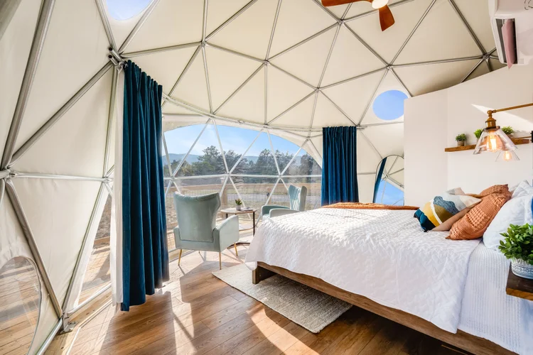 Dome interior with king bed and panoramic window