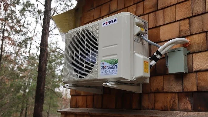 hvac mini split attached to outside of cottage