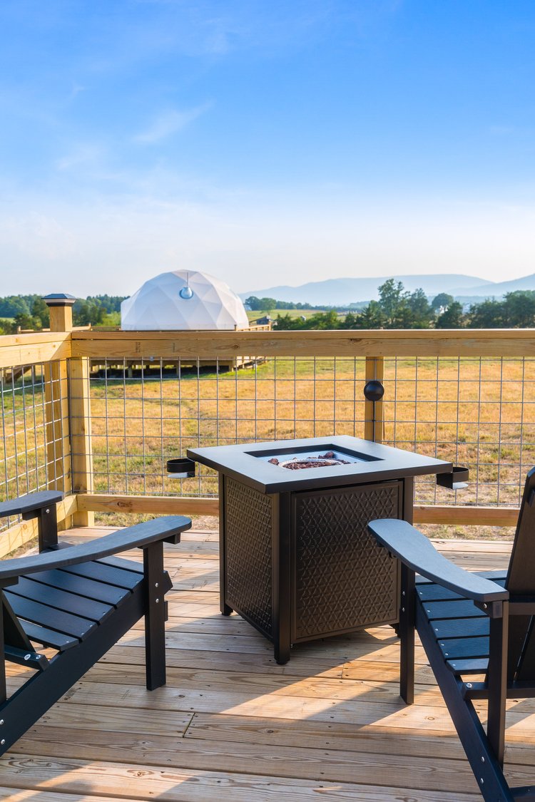 Fire pit and chairs overlooking dome and mountains