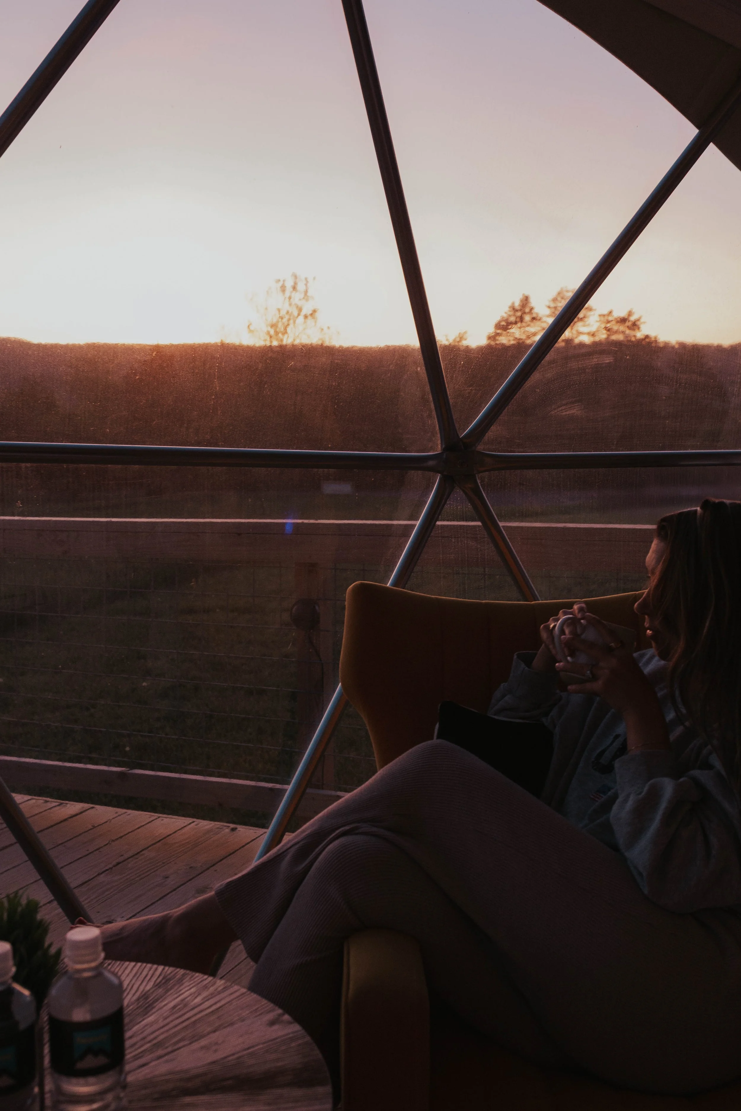 girl sitting in front of geodome window