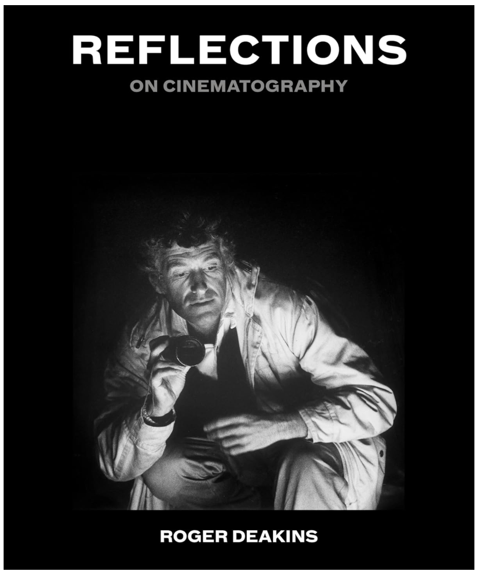 Book cover titled 'Reflections on Cinematography' featuring a black-and-white photo of Roger Deakins holding a camera, crouching down, and looking into the distance.