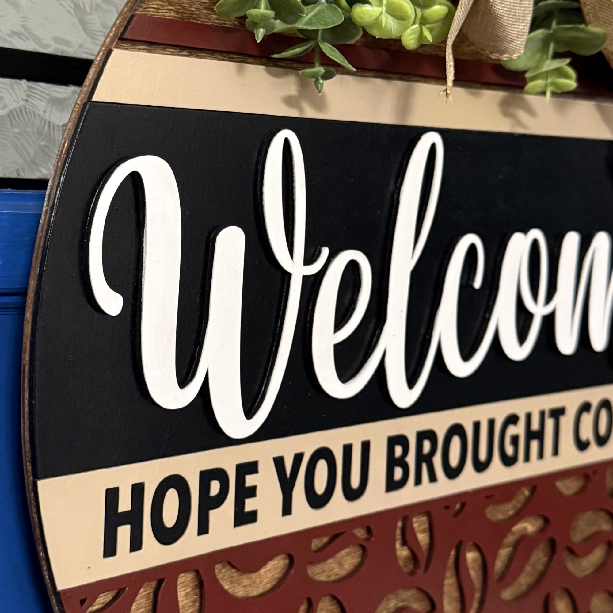 Side angle of door hanger highlighting dimensional coffee bean cutouts