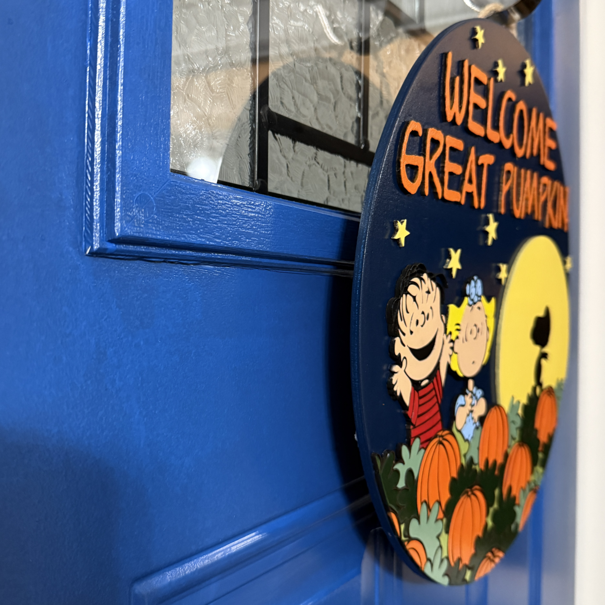 Side view of Welcome Great Pumpkin door hanger showing layered cutouts and painted details