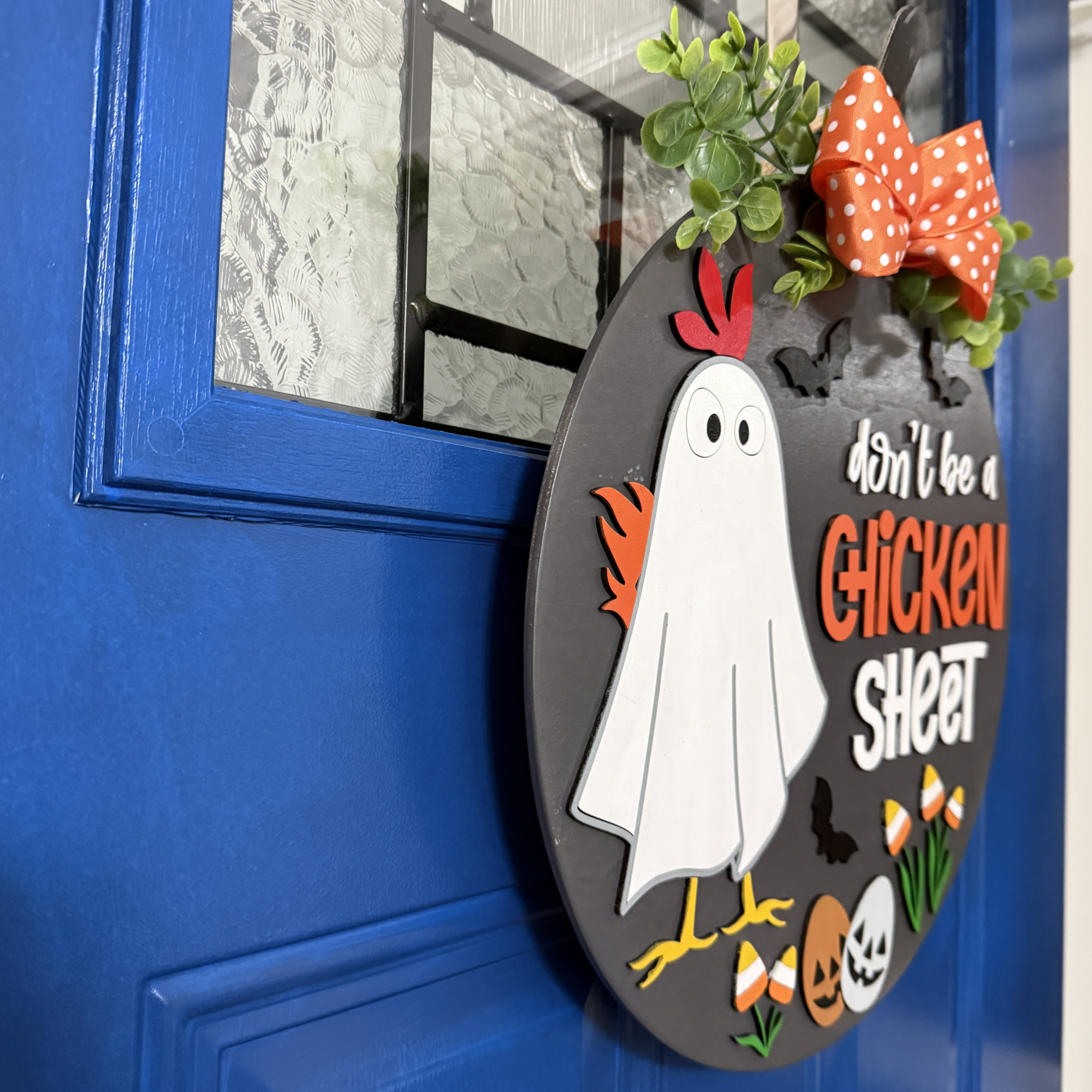 Side view of layered wood Halloween door hanger showing dimensional details and painted finish