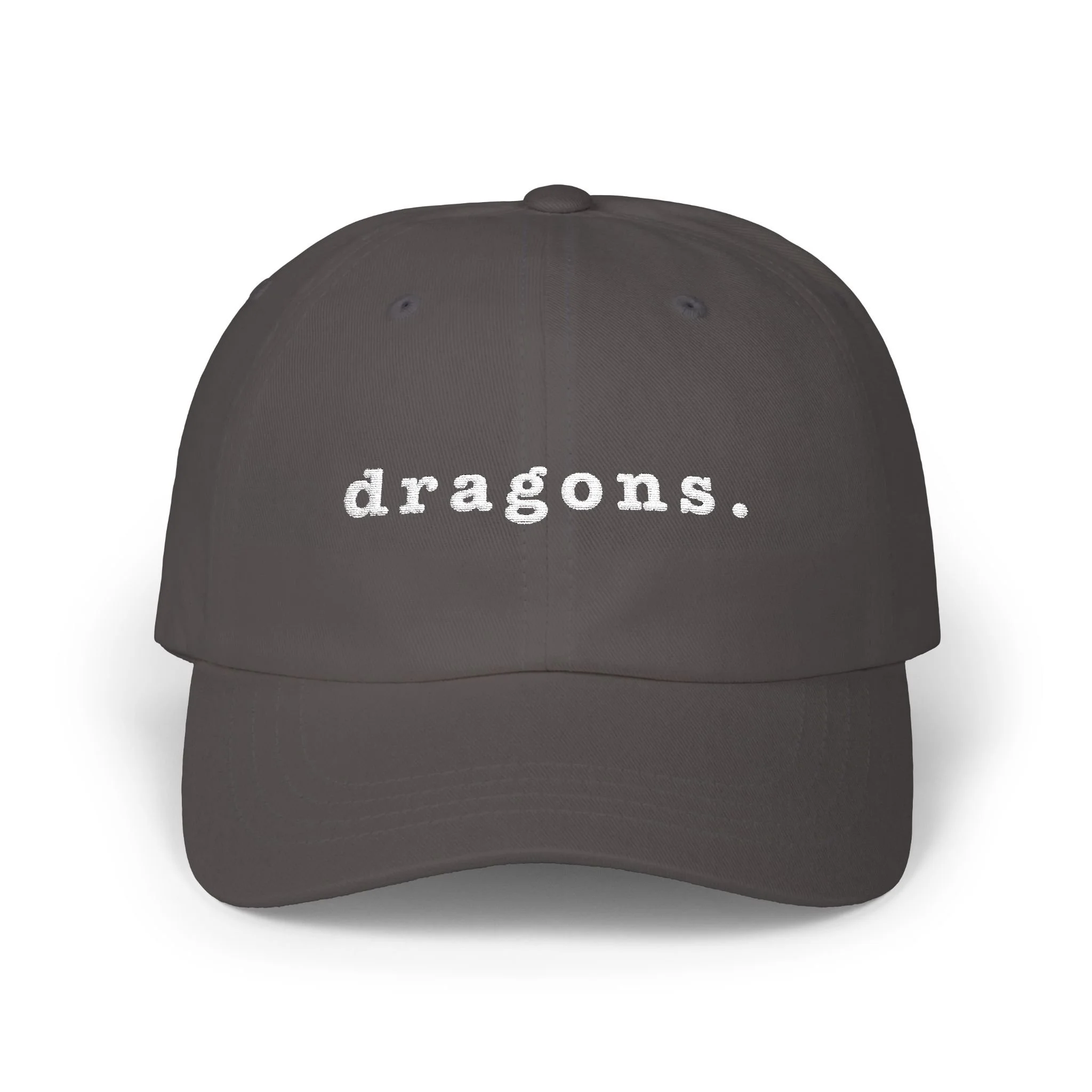 Dark gray dad cap on white background displaying embroidered “dragons.” text on the front.