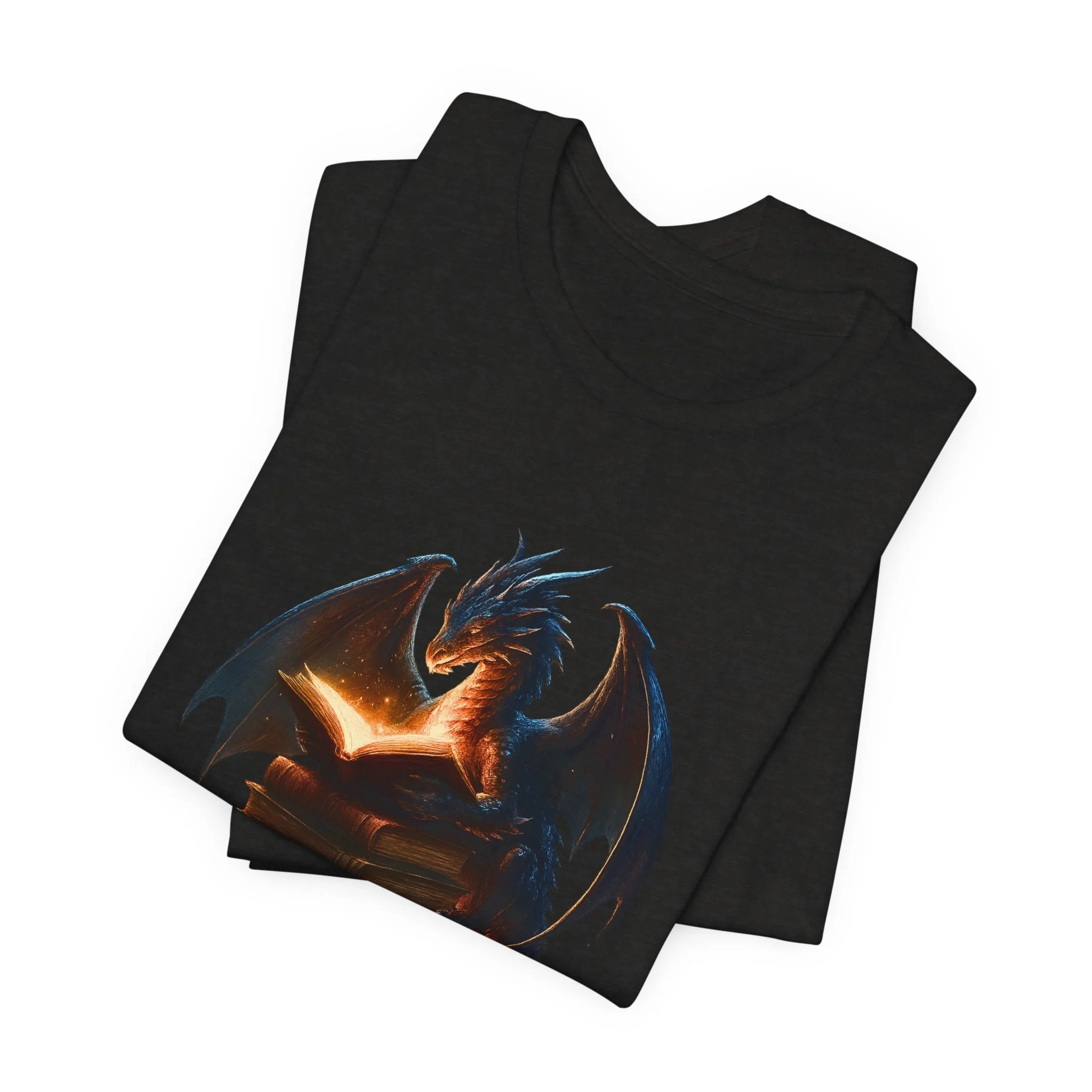 Folded black t-shirt with fantasy dragon reading a glowing book graphic