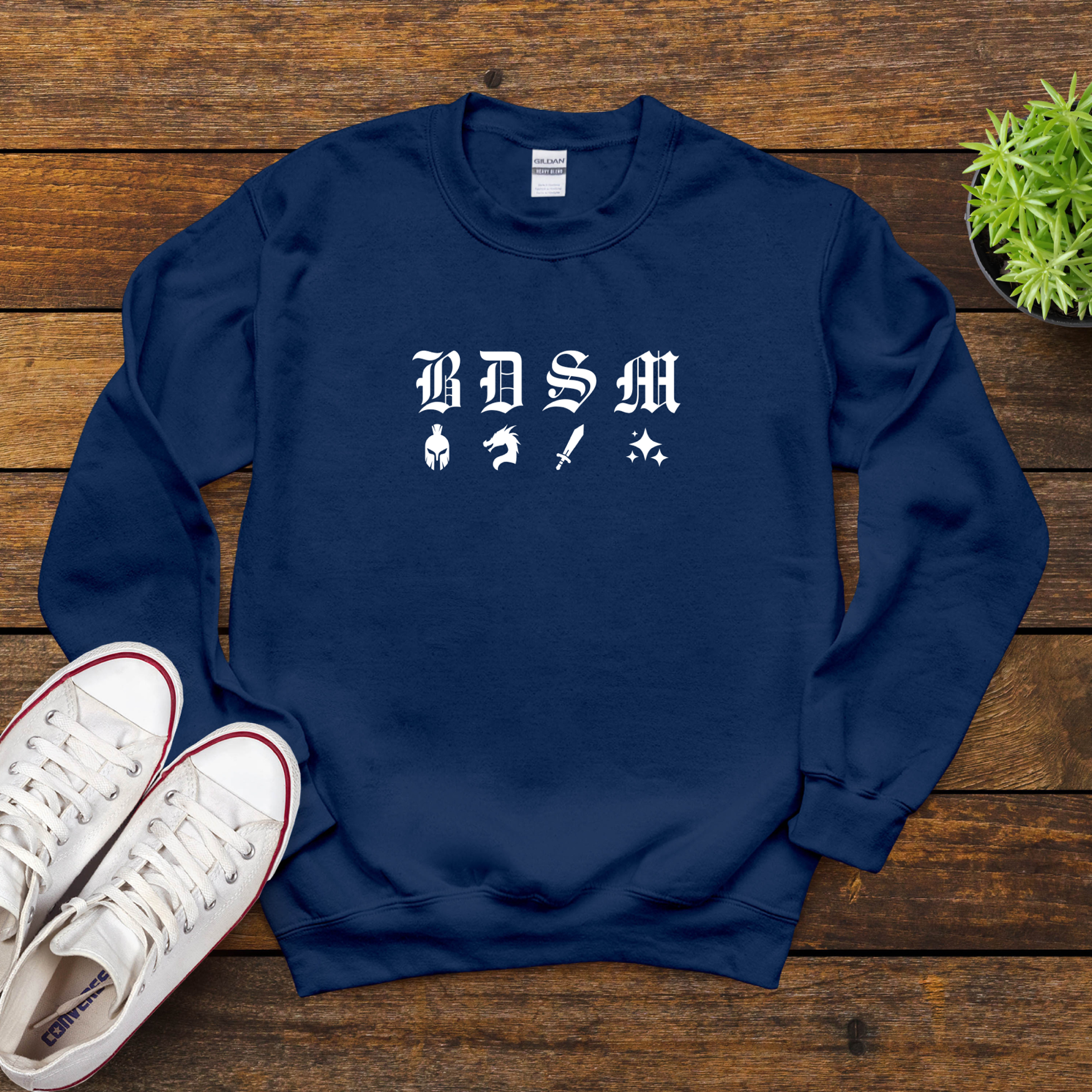 Navy fantasy B D S M sweatshirt on wooden background with shoes, white warrior icons and gothic lettering.
