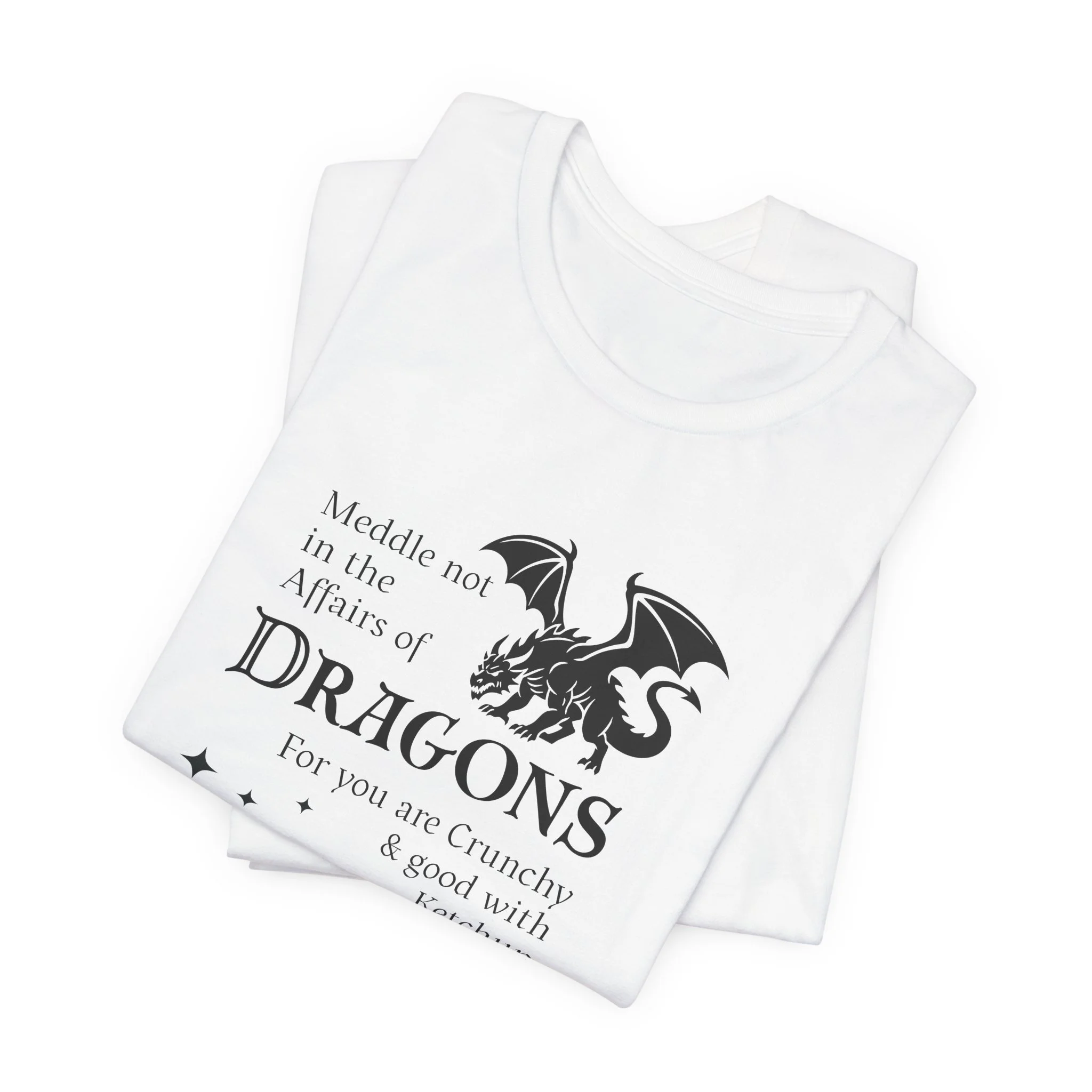 Folded white dragon quote t-shirt with dark dragon silhouette and decorative stars.