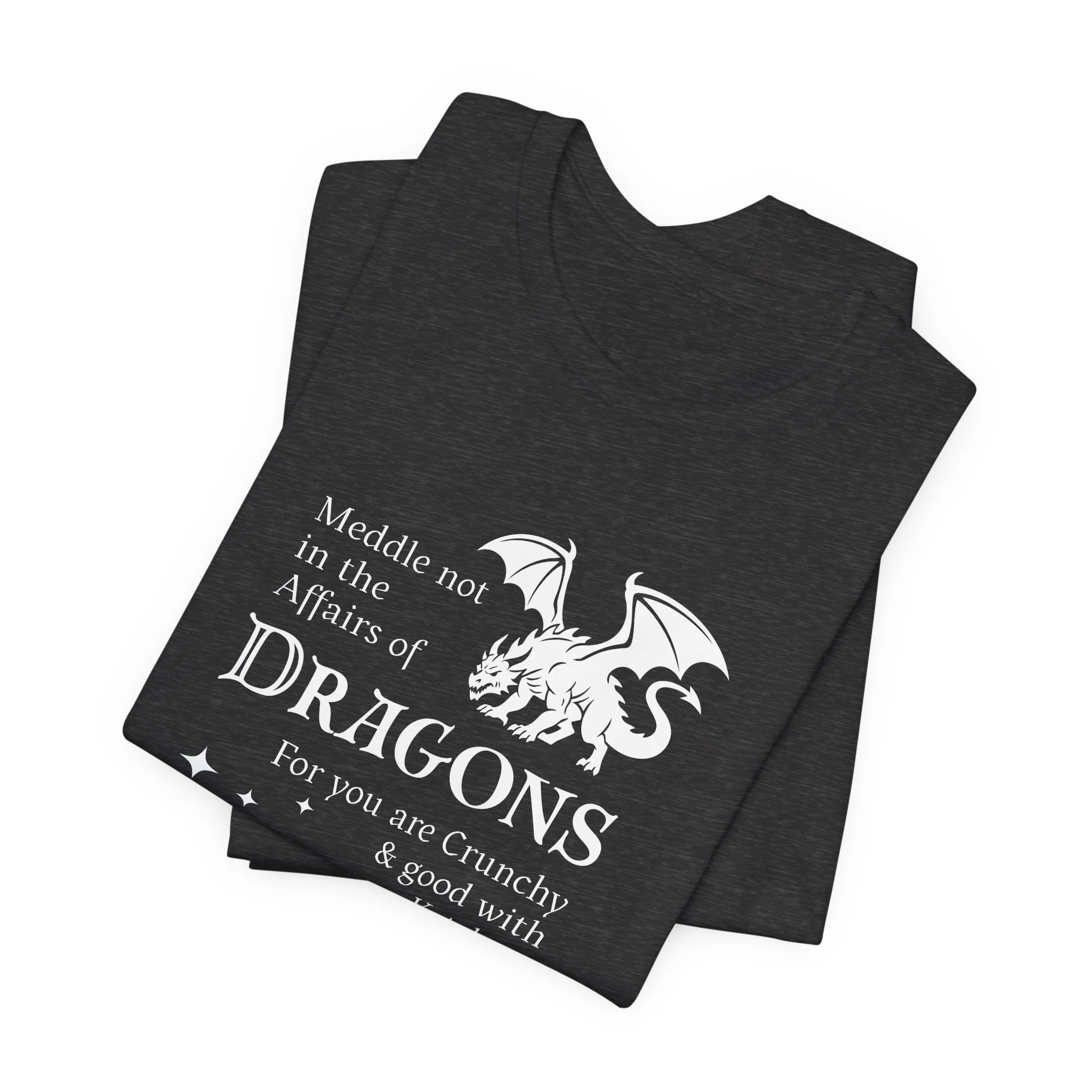 Folded heather black t-shirt featuring white dragon silhouette and quote with star accents.
