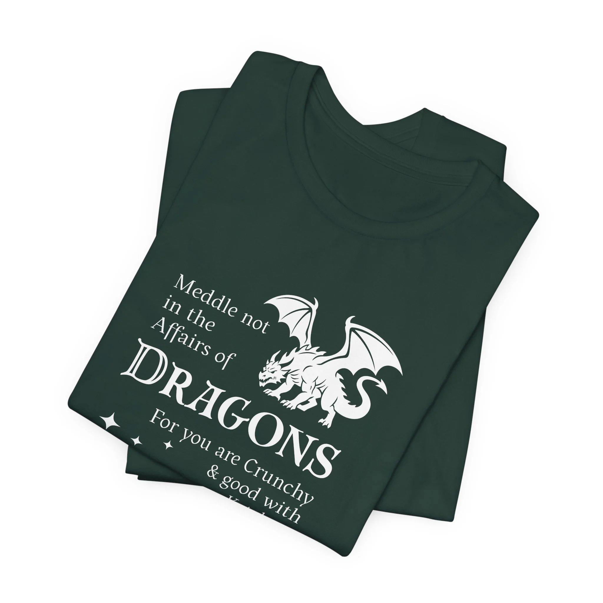 Folded forest green t-shirt featuring white dragon artwork and quote with star cluster.