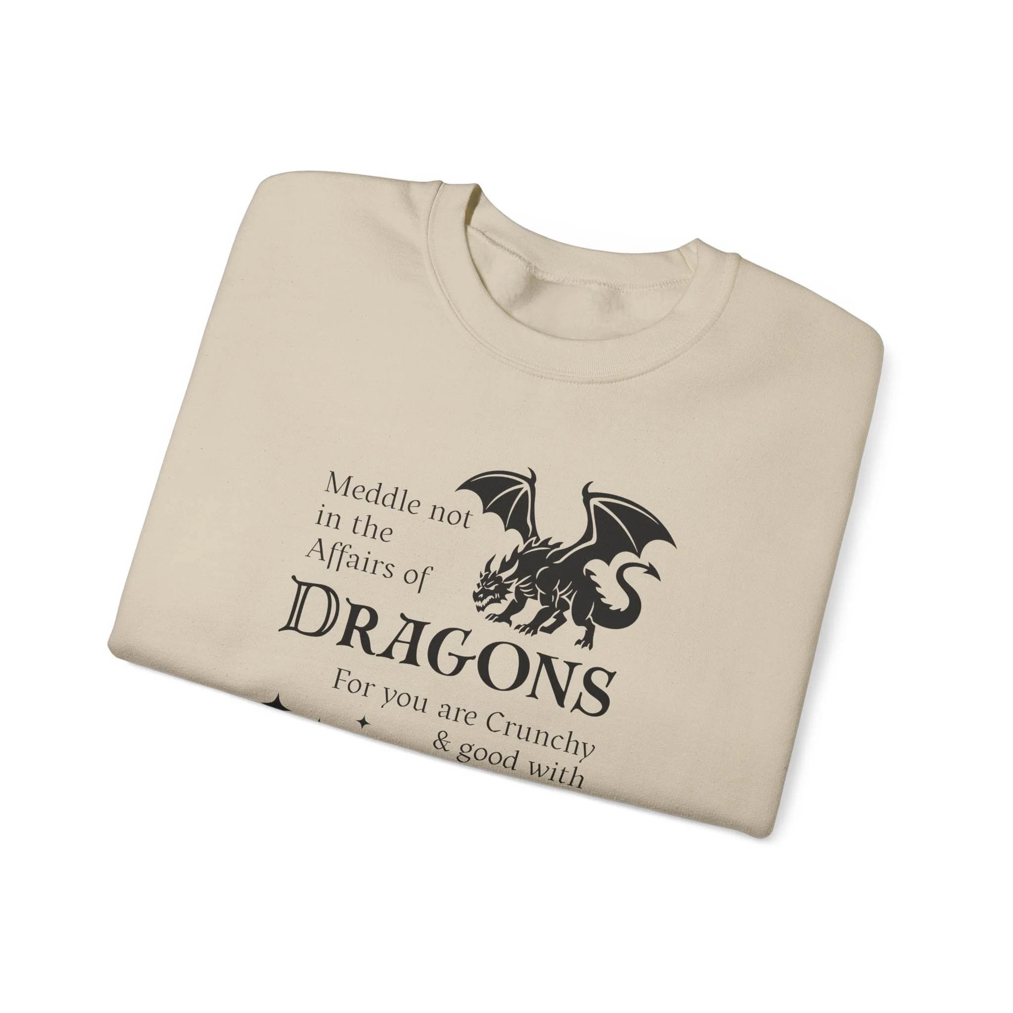 Sand-colored folded sweatshirt with black dragon graphic and humorous dragon-themed warning text.