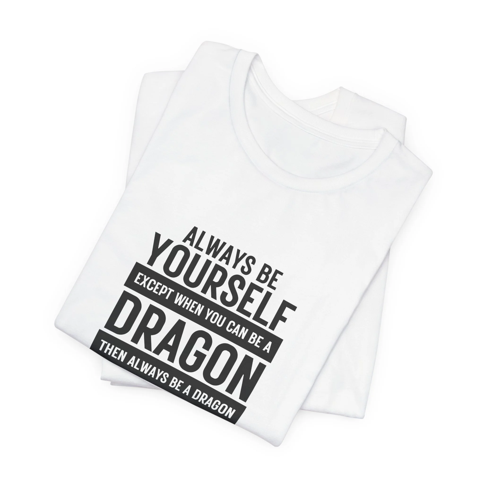 Folded white unisex T-shirt with black block-style dragon quote design.