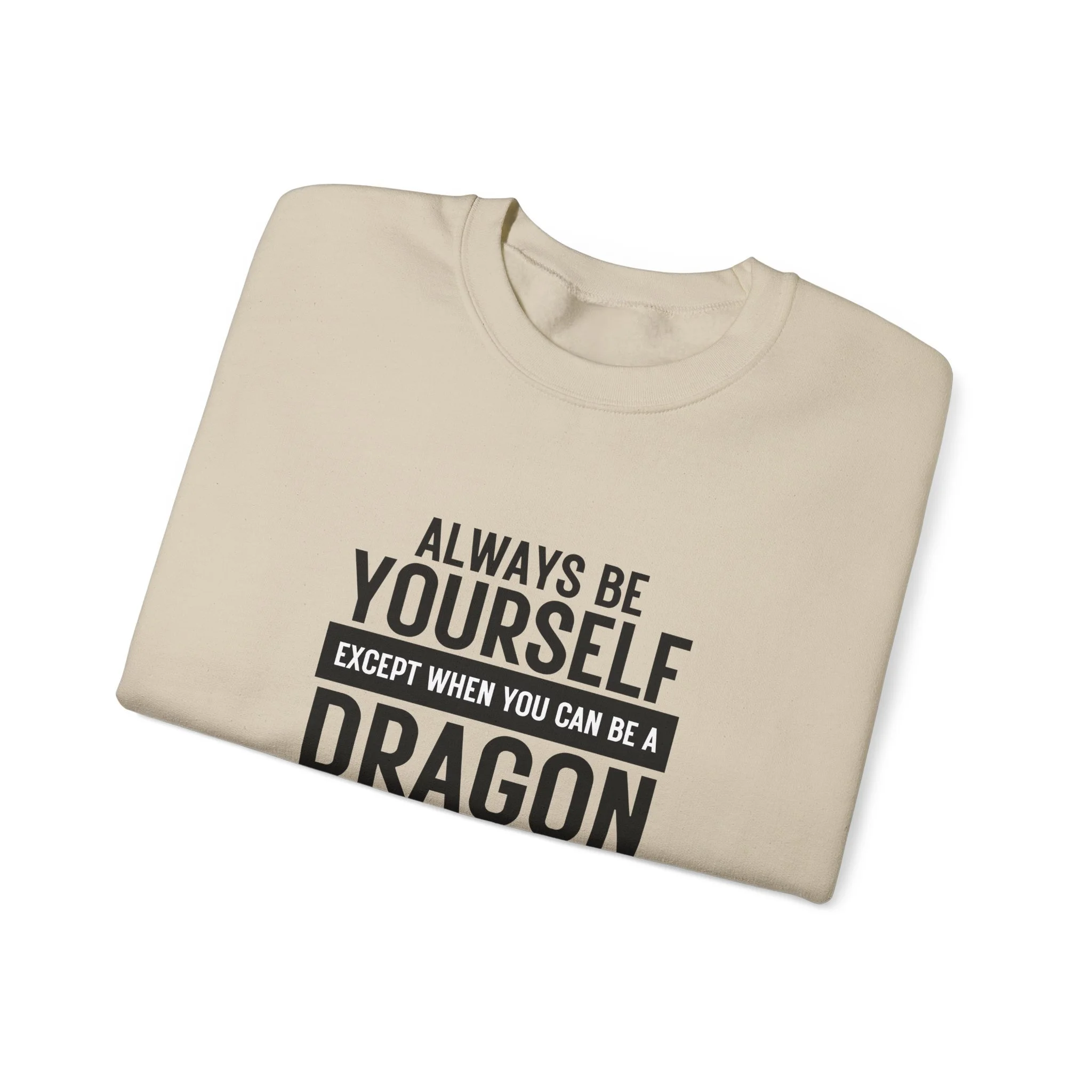 Folded sand-colored sweatshirt with black block-text dragon quote centered on the front.