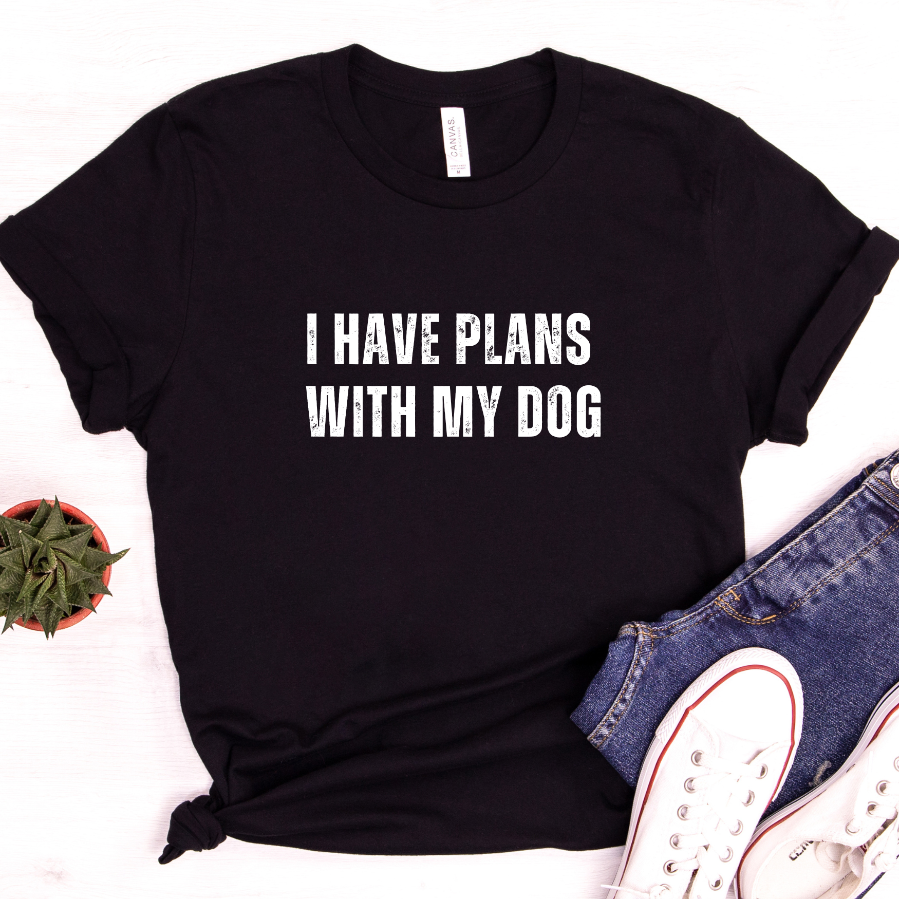 Styled flat lay of black dog lover t-shirt tied at waist with casual accessories