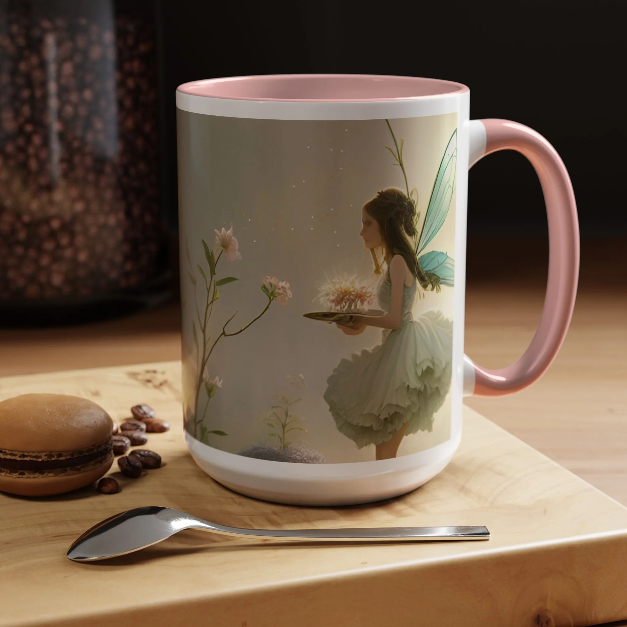 Lifestyle view of lavender fairy mug with soft pink interior, wraparound fairy and floral artwork, on a wooden table with spoon and cookies