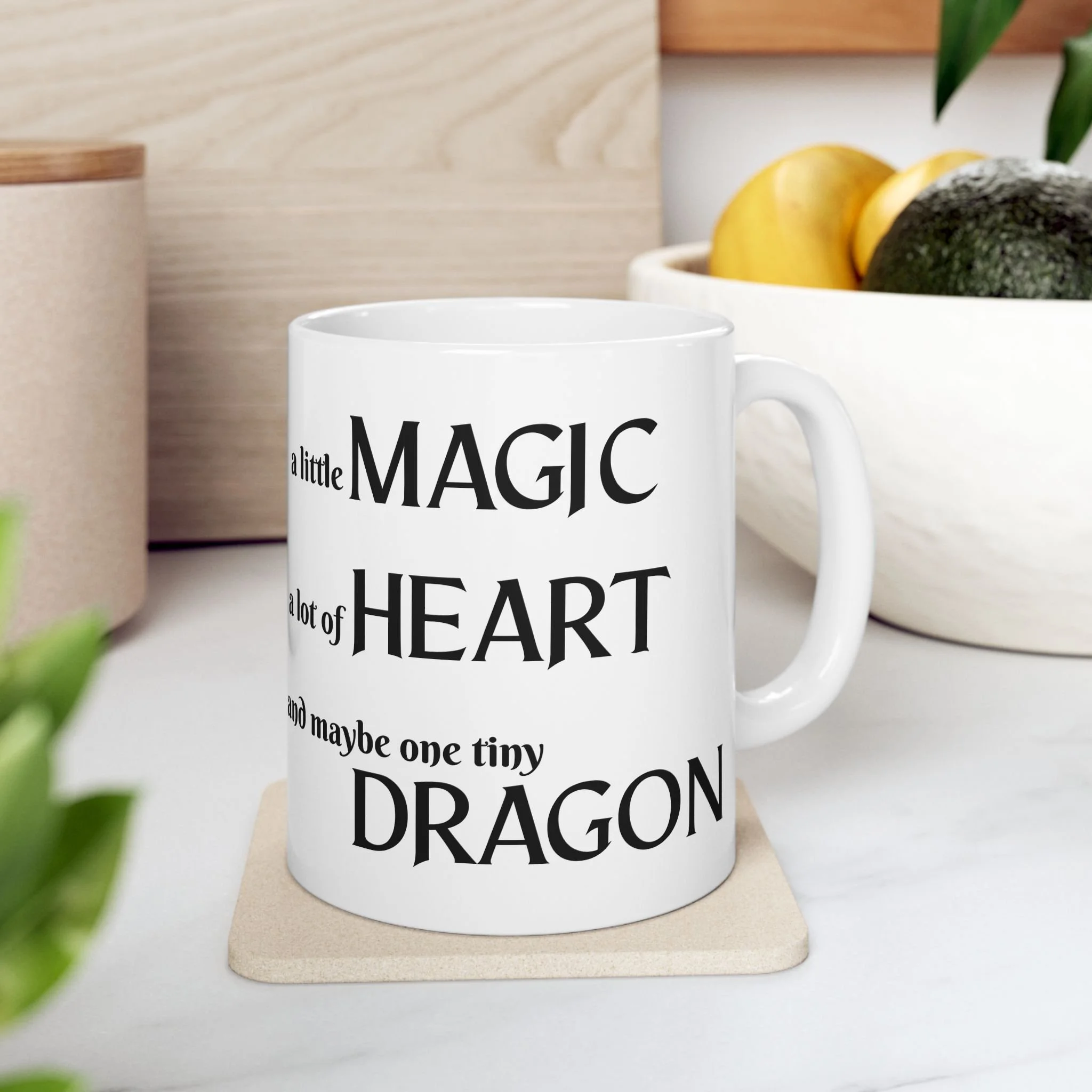 Front view of white ceramic fantasy mug with quote a little magic a lot of heart and maybe one tiny dragon