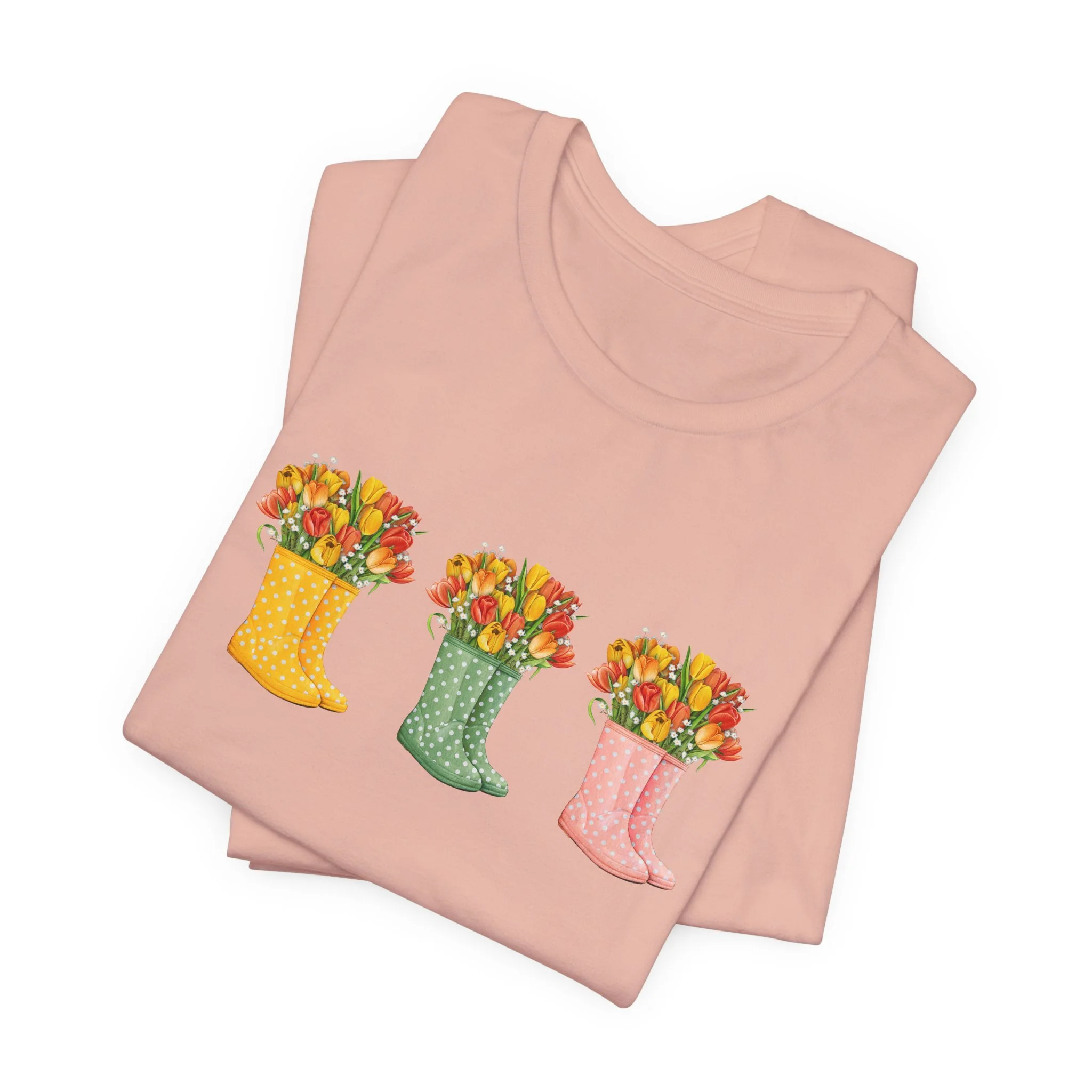 Folded peach t-shirt featuring Floral Rain Boots graphic