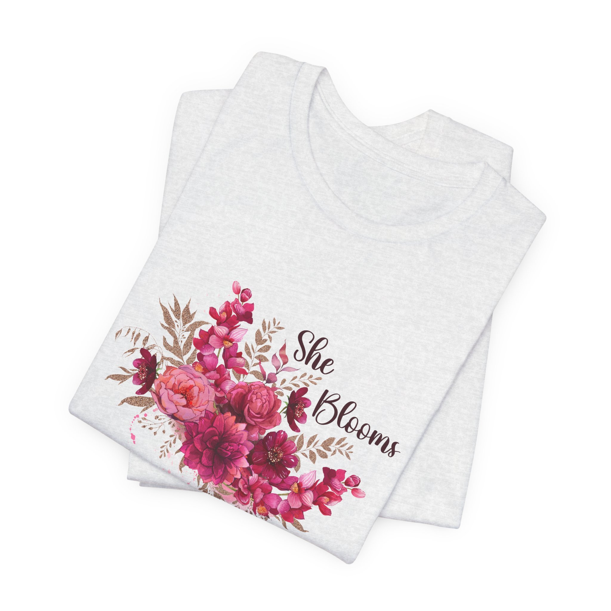 Folded ash gray t-shirt featuring She Blooms graphic