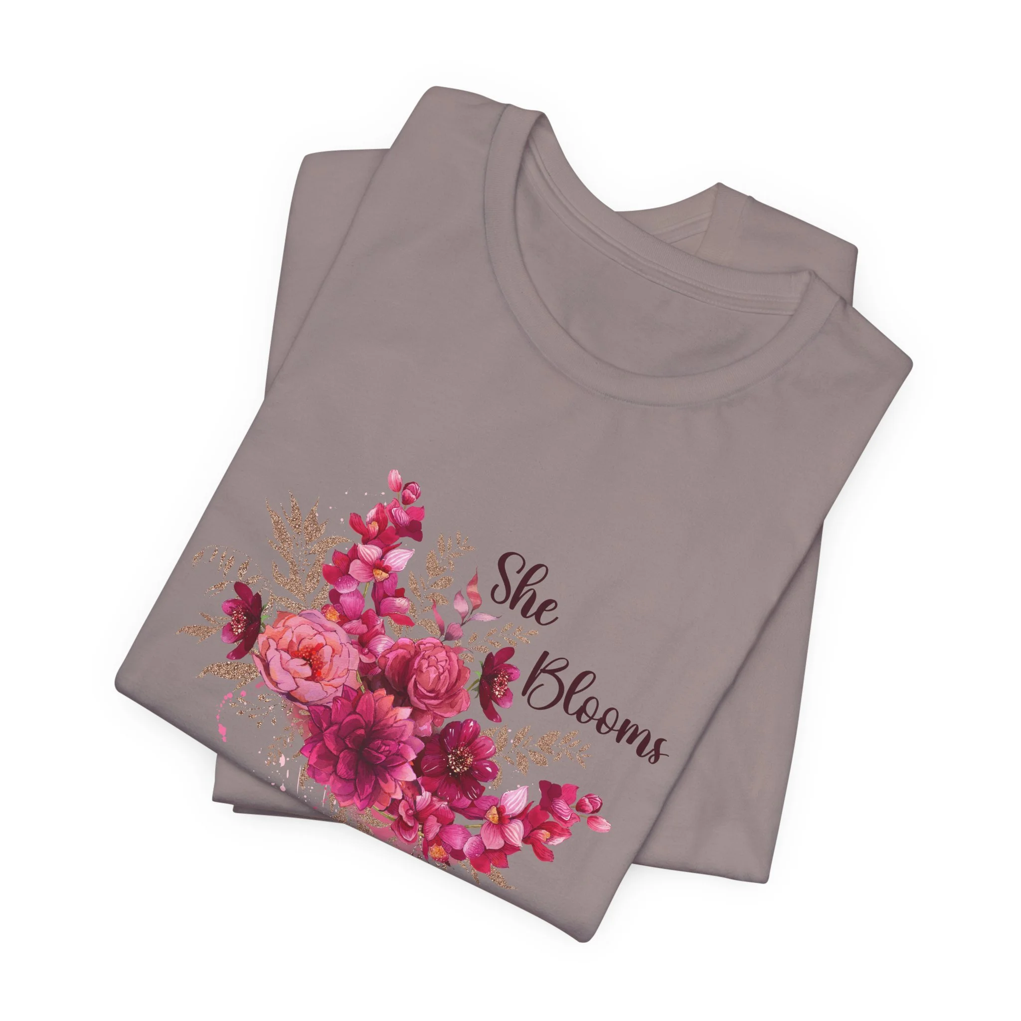 Folded pebble brown t-shirt featuring She Blooms graphic
