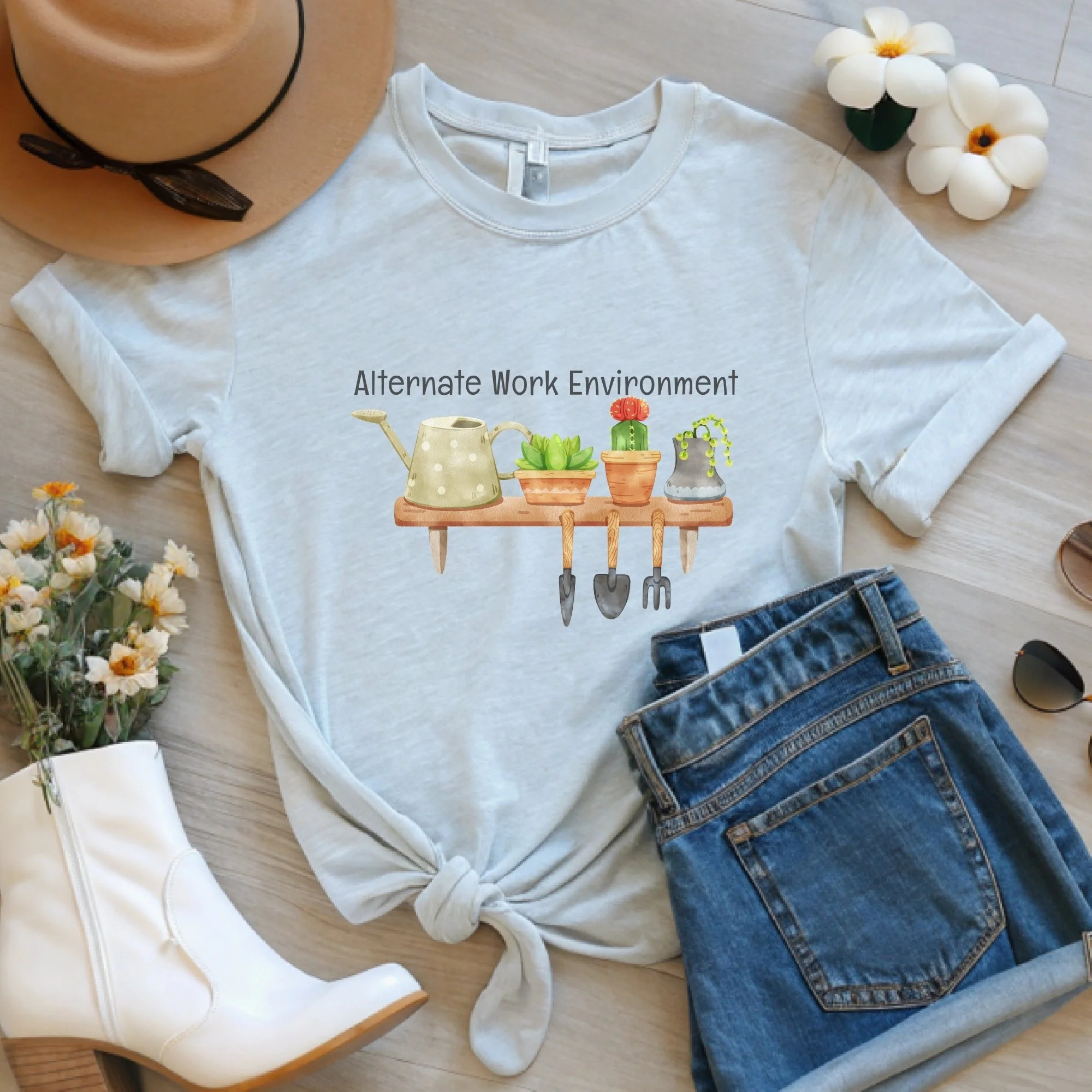 Daytime styled view of Alternate Work Environment graphic shirt on ash gray tee with jeans, sneakers, and spring accessories