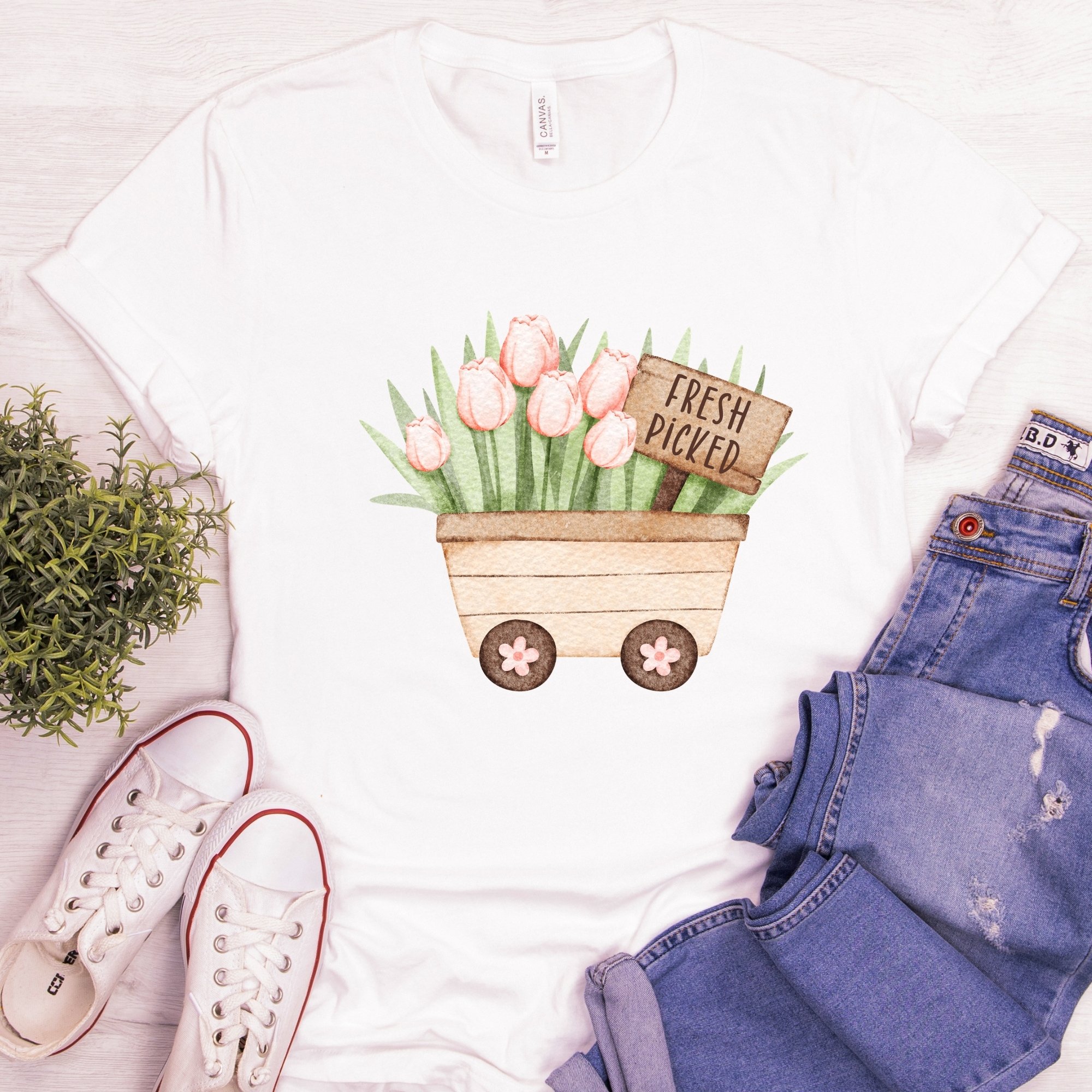 Daytime styled view of Fresh Picked Tulips wagon graphic shirt on white tee with jeans, sneakers, and spring accessories