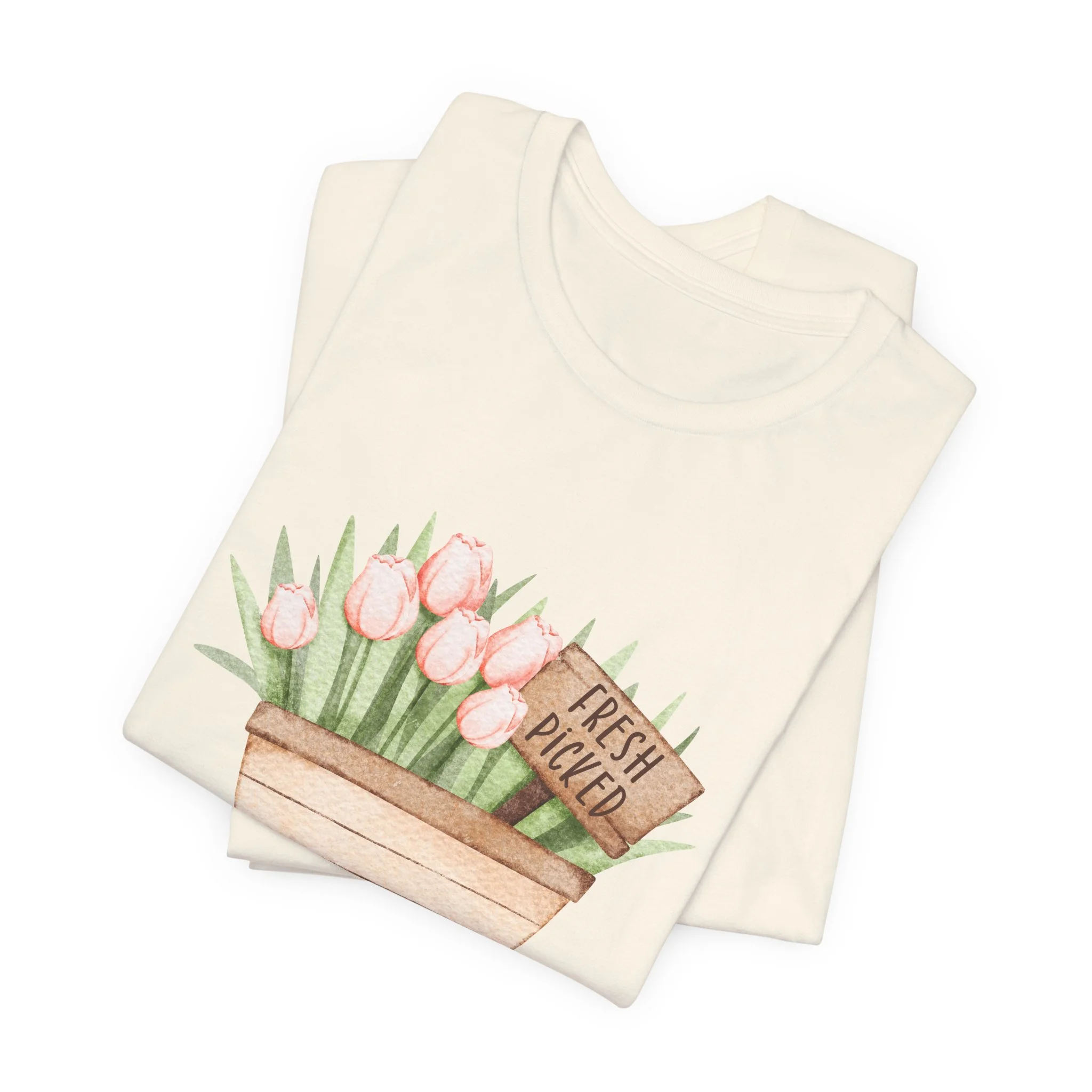 Folded natural cream t-shirt featuring Fresh Picked Tulips wagon graphic