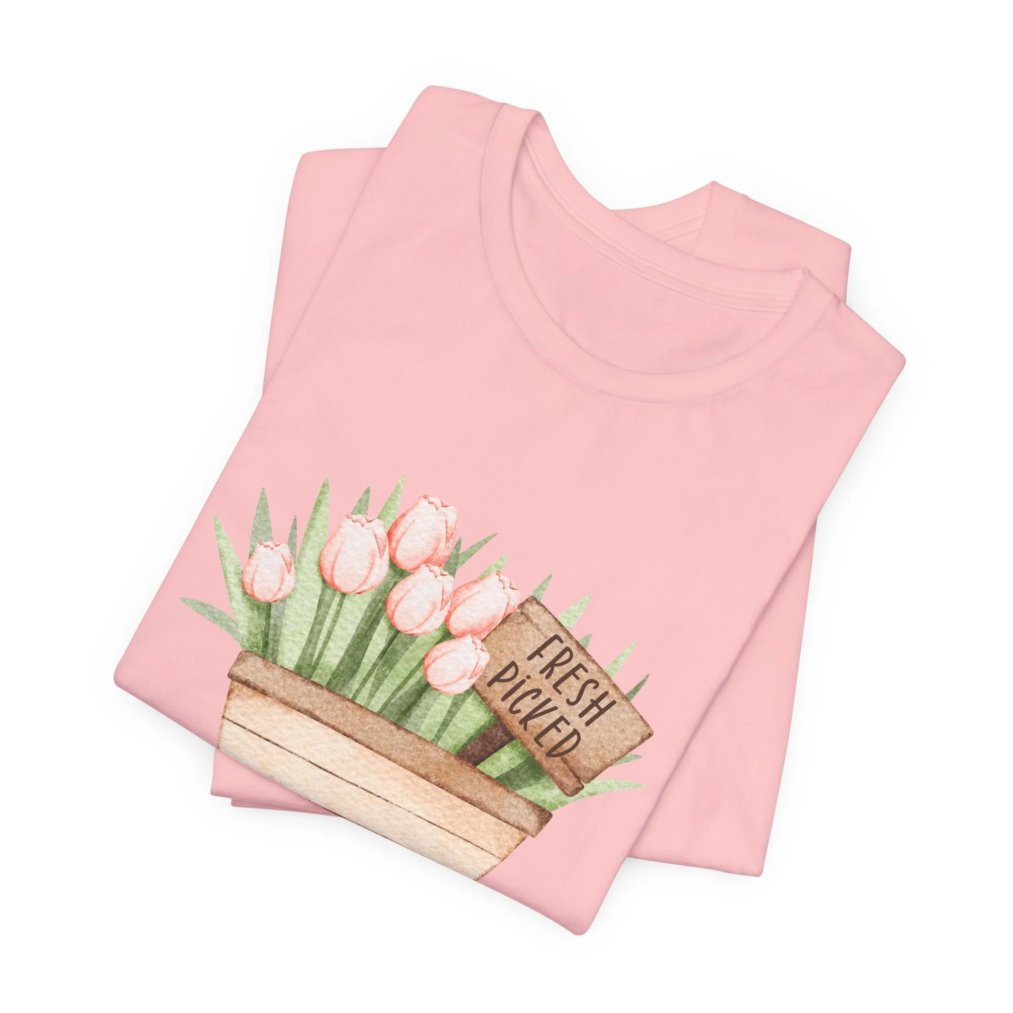 Folded soft pink t-shirt featuring Fresh Picked Tulips wagon graphic