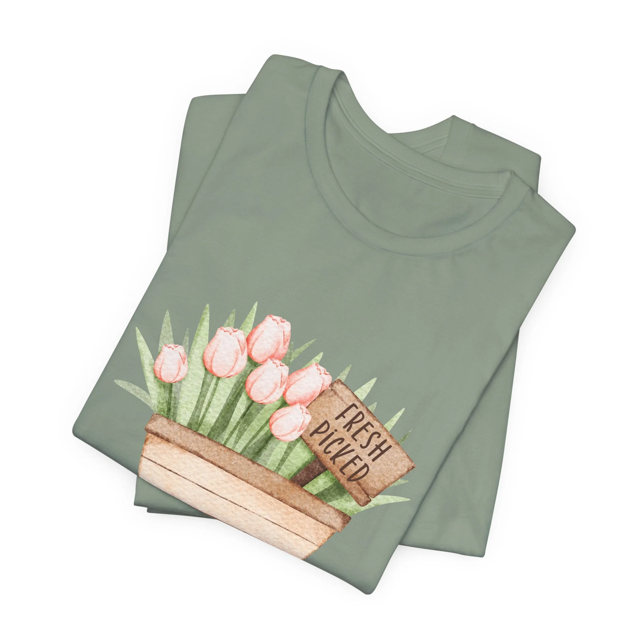 Folded sage green t-shirt featuring Fresh Picked Tulips wagon graphic