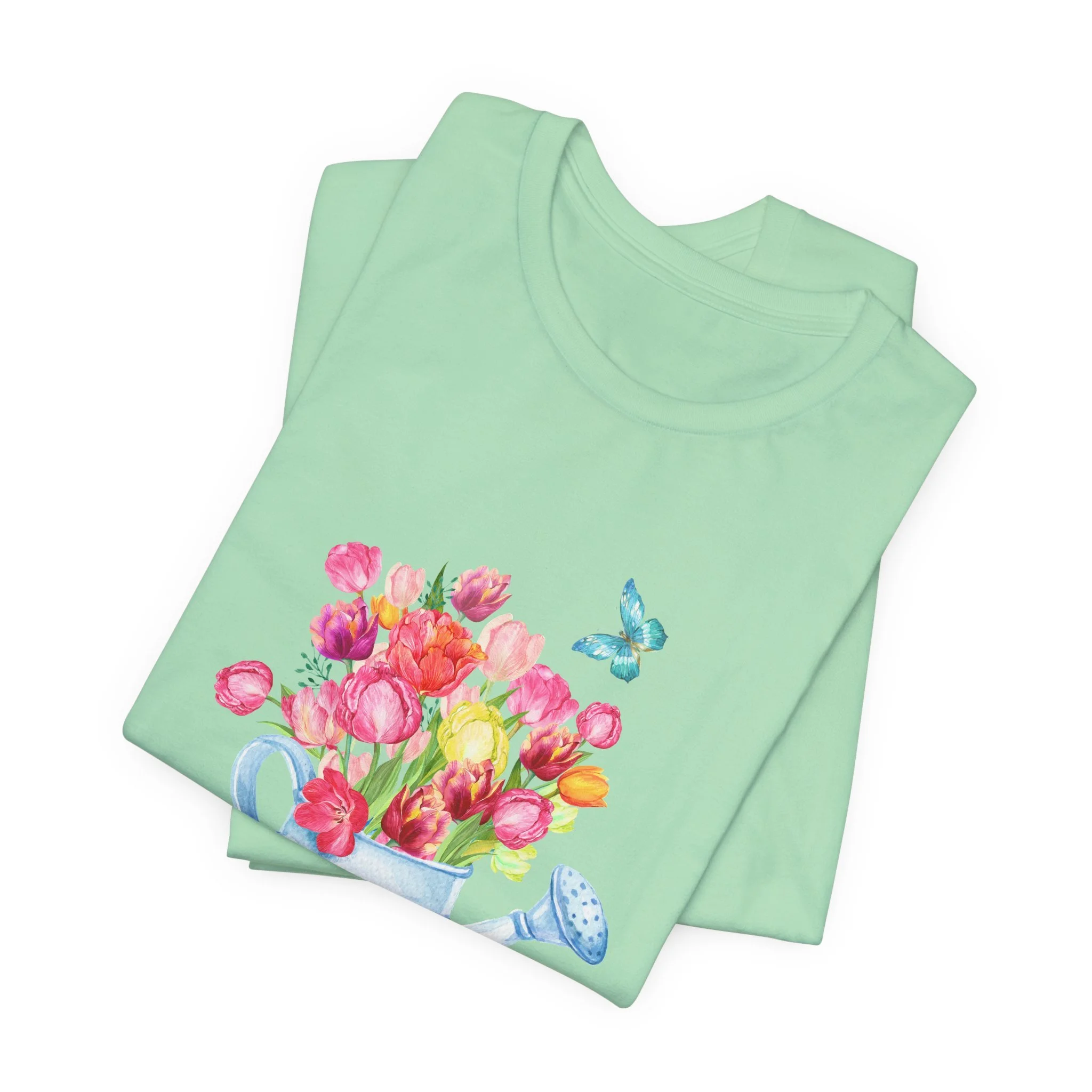 Folded mint green t-shirt featuring Tulips in Watering Can graphic