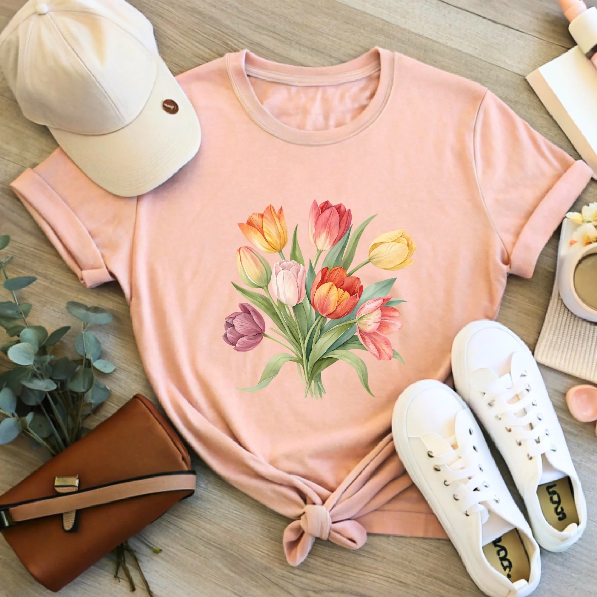 Daytime styled view of Tulip Bouquet graphic shirt on peach tee with jeans, sneakers, and spring accessories
