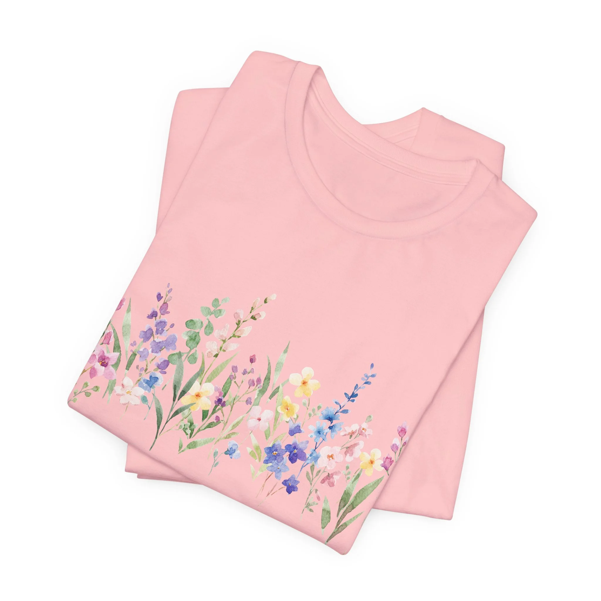 Folded soft pink t-shirt with delicate watercolor wildflower border illustration