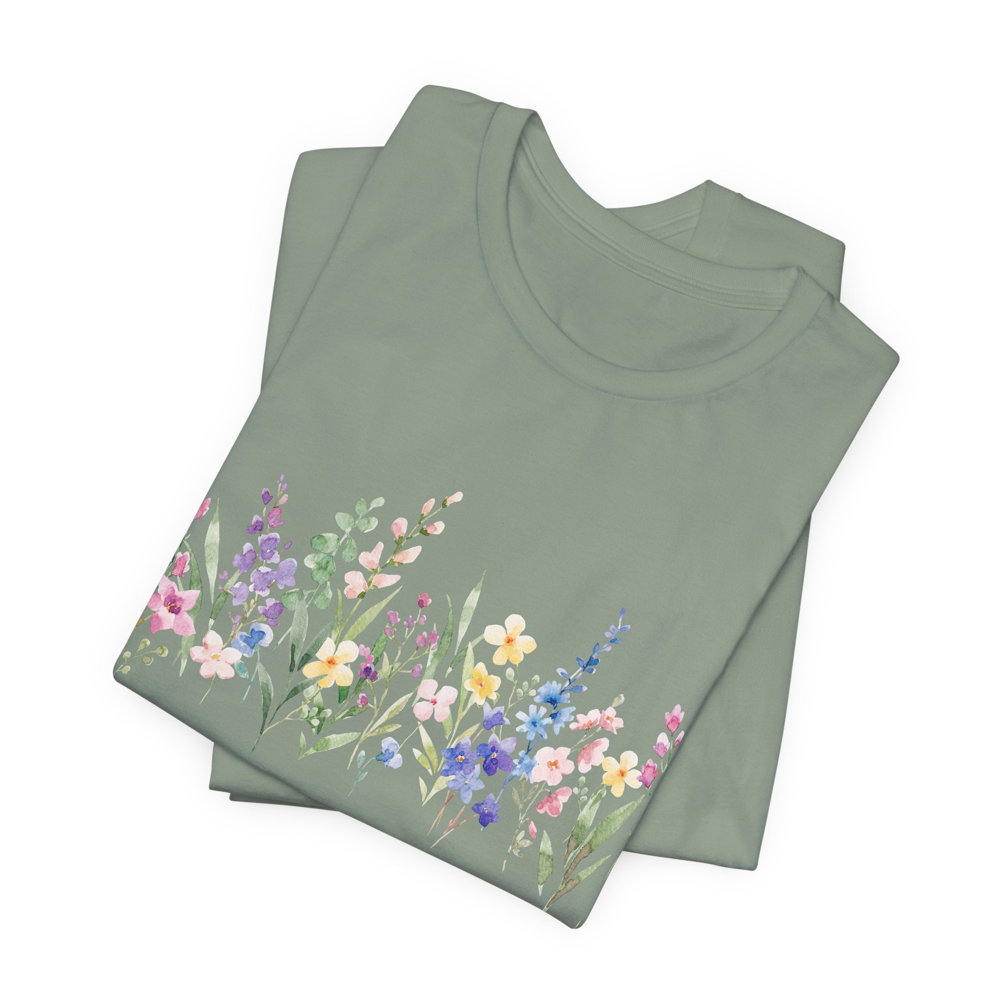 Folded sage green t-shirt featuring pastel wildflower border graphic