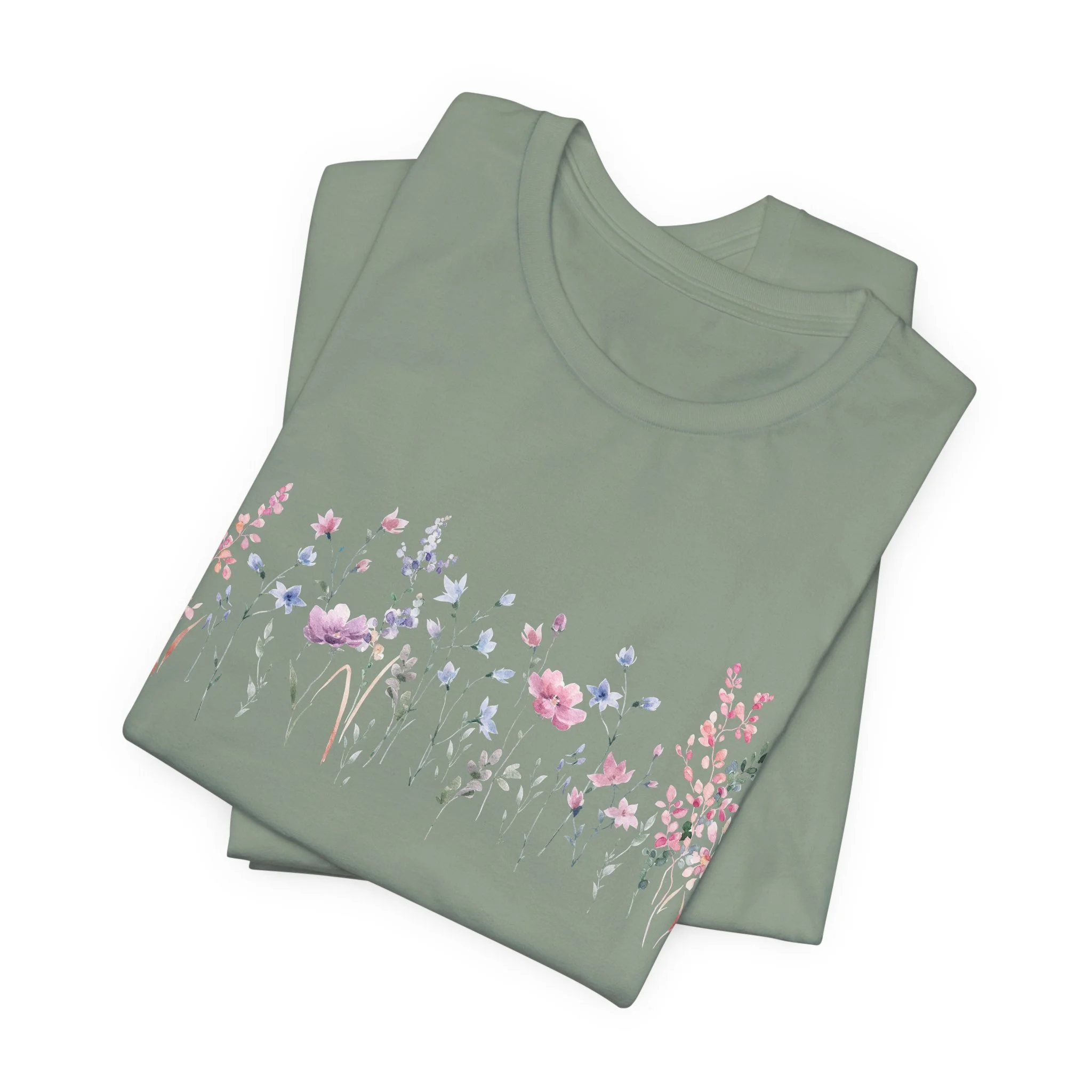 Folded sage green t-shirt with delicate pastel wildflower border illustration