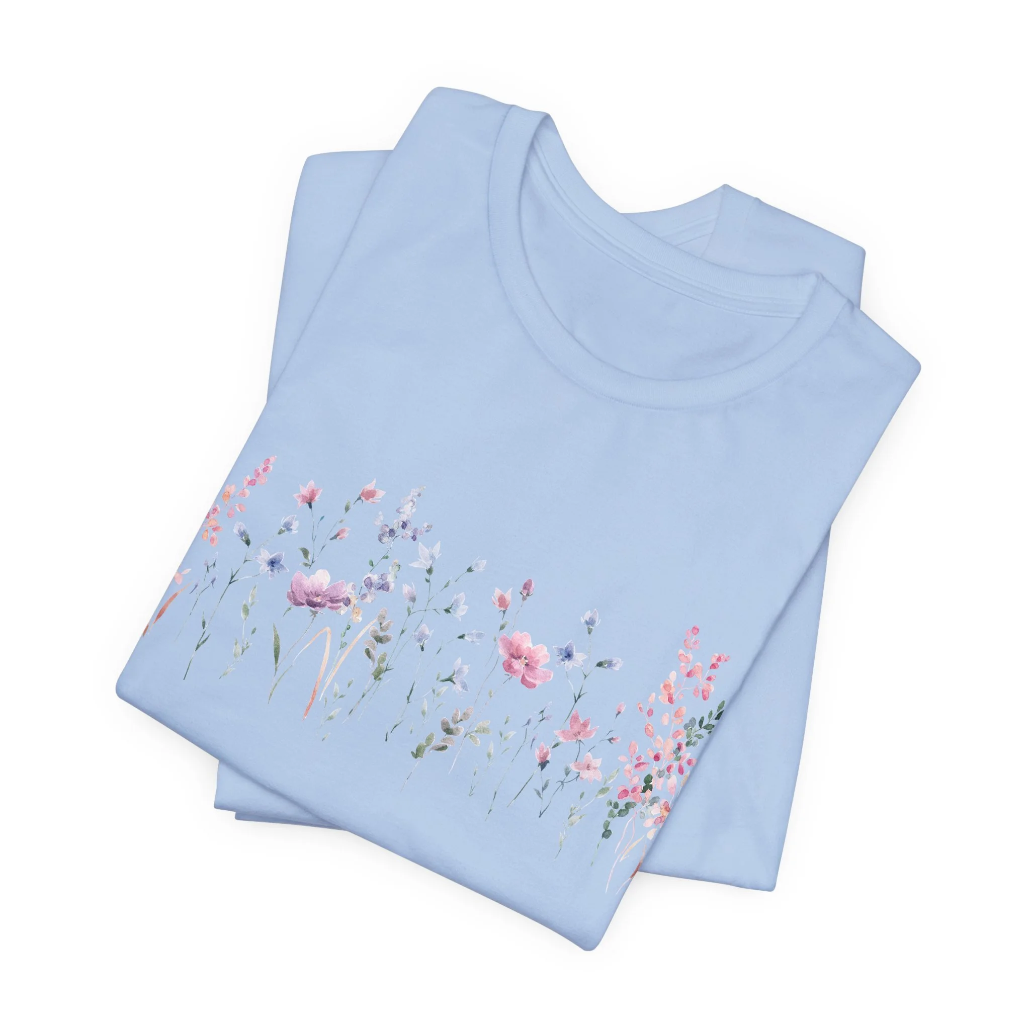 Folded baby blue t-shirt with pastel watercolor wildflower border graphic