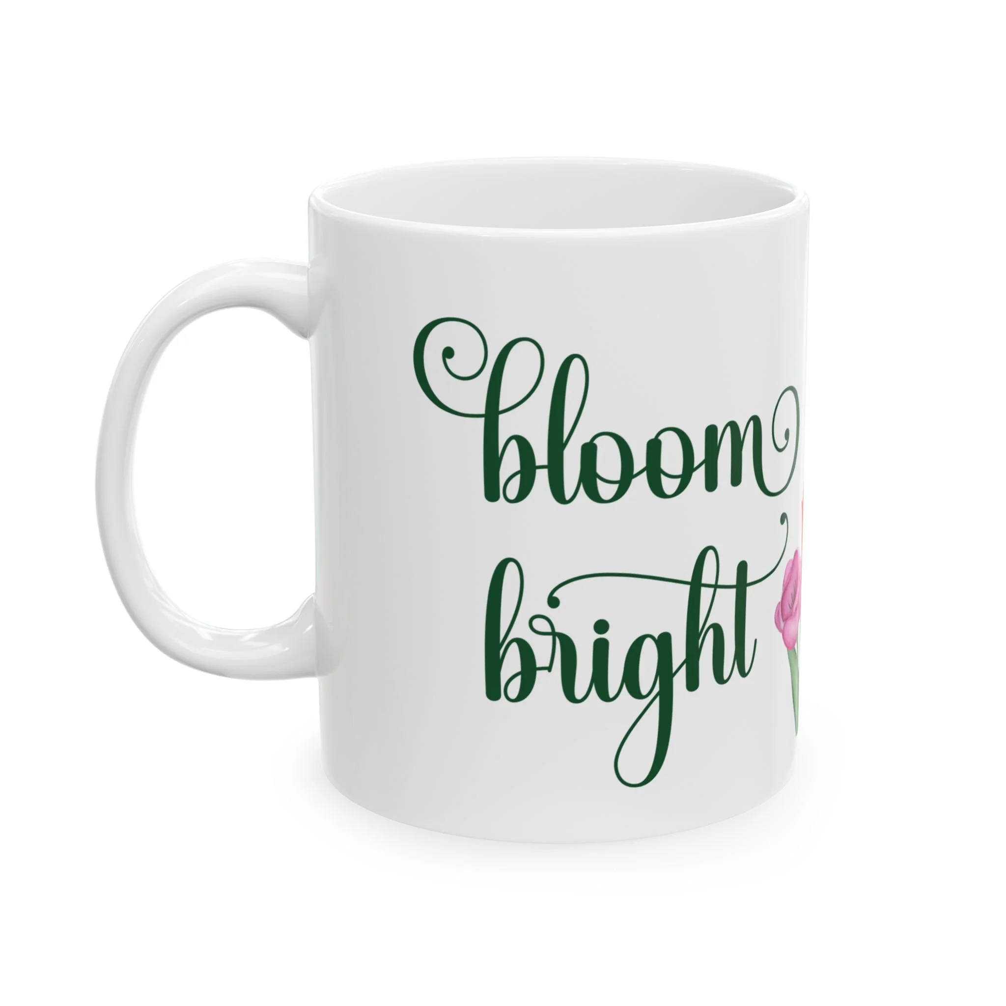 Front view of white ceramic mug with bloom bright text in green and small pink butterfly
