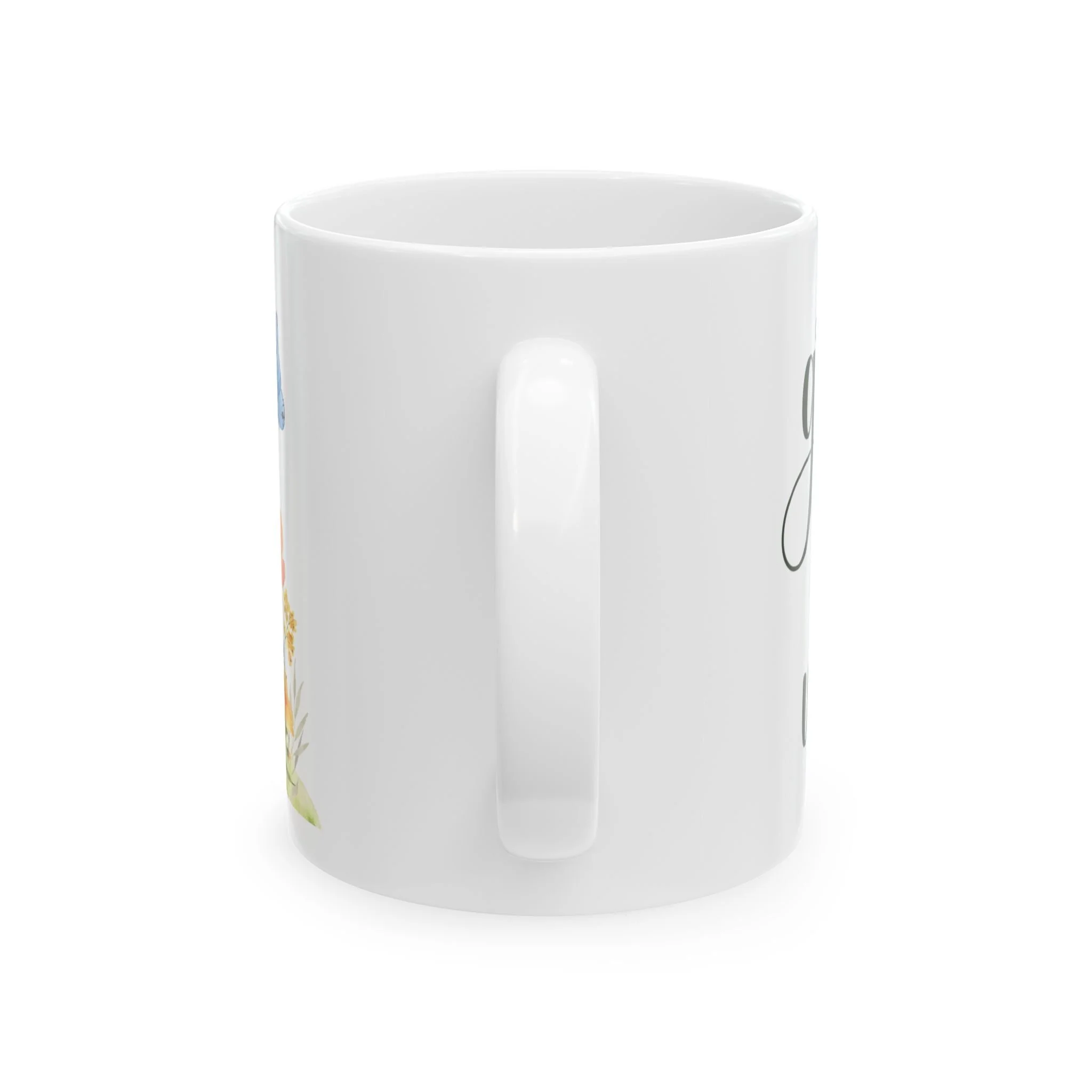 Side profile of mug showing white handle and partial floral design