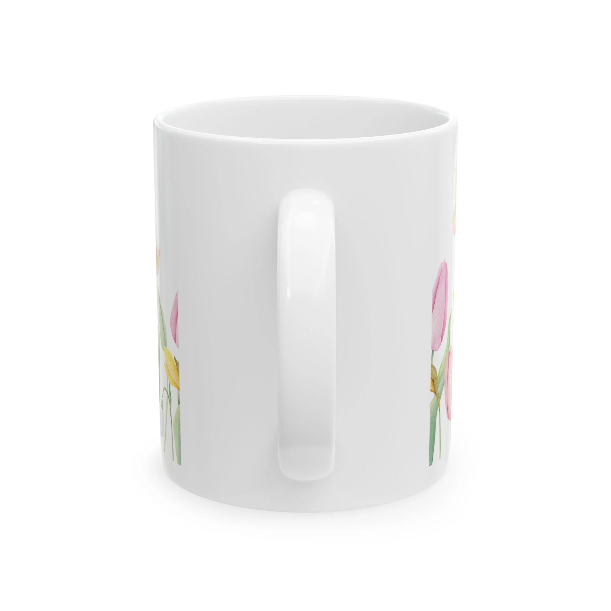 Side profile of mug showing white handle and partial floral design