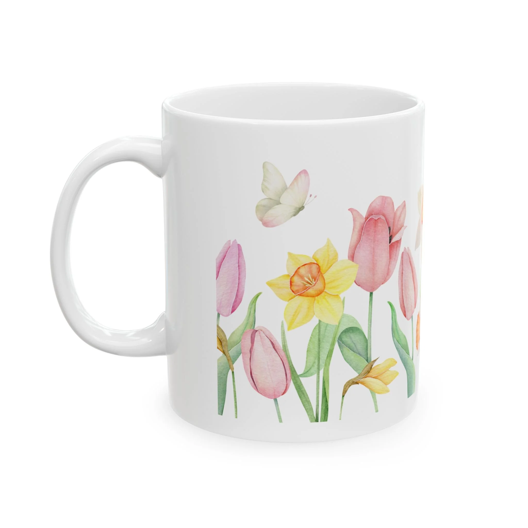 Front view of white ceramic mug with pastel tulips and yellow daffodils