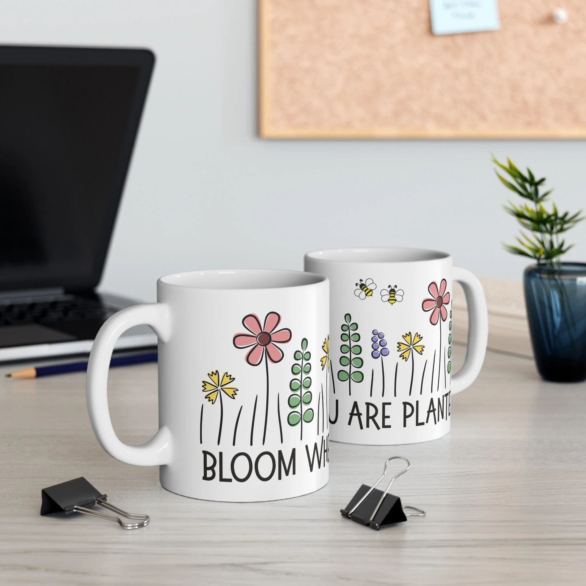 Styled desk scene with two bloom where you are planted mugs featuring colorful flowers and inspirational quote
