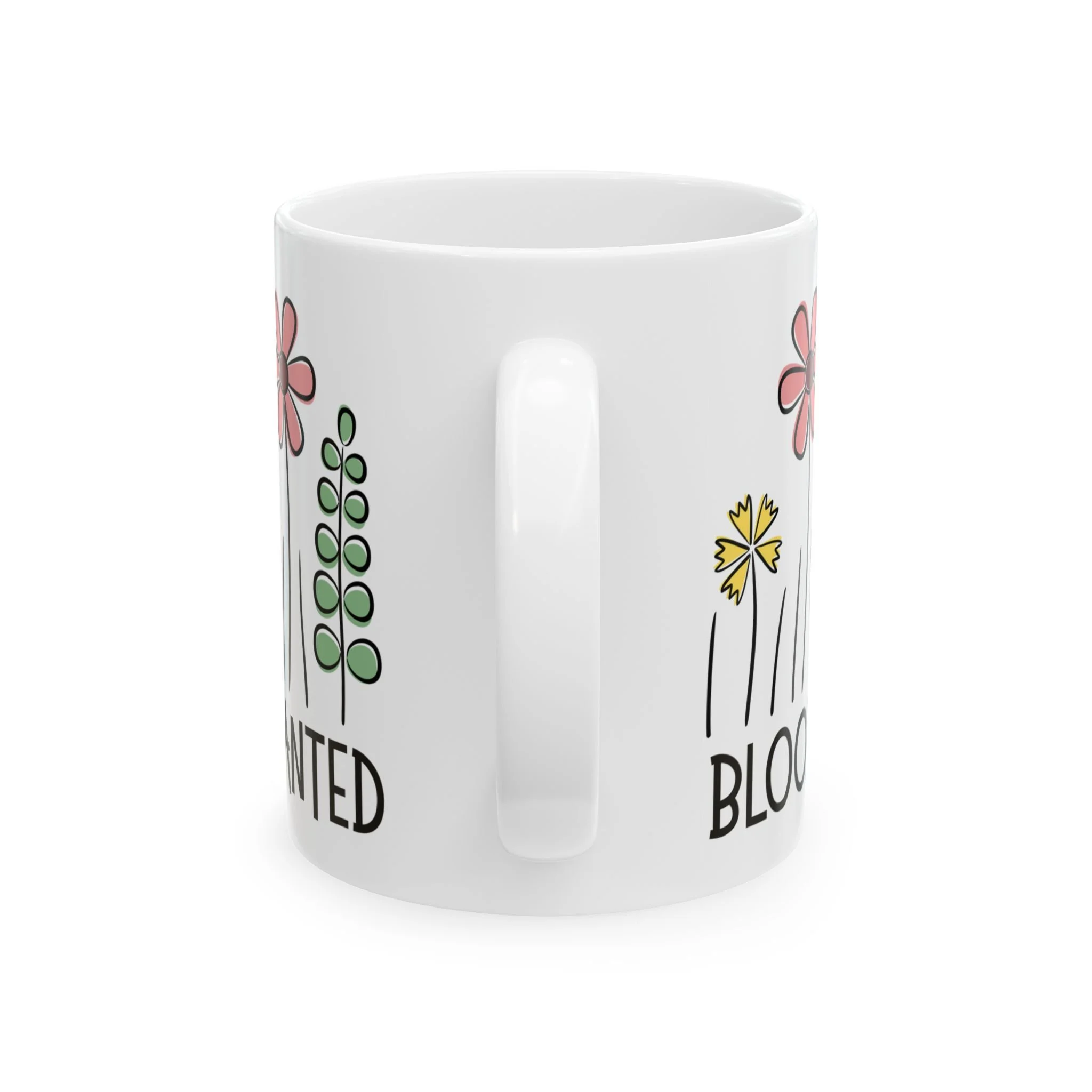 Side profile of mug showing white handle and partial floral artwork