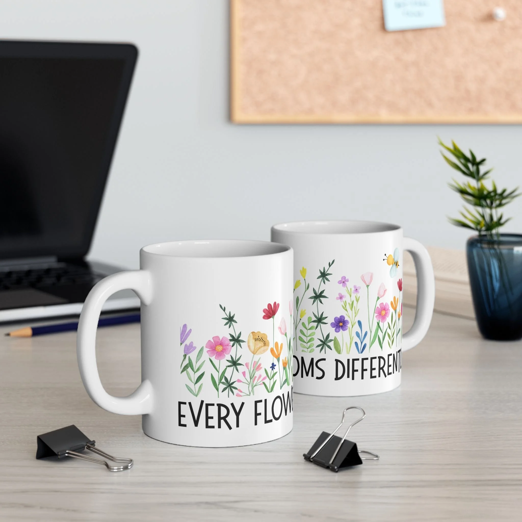 Styled desk scene with two every flower blooms differently mugs featuring colorful wildflowers and inspirational quote